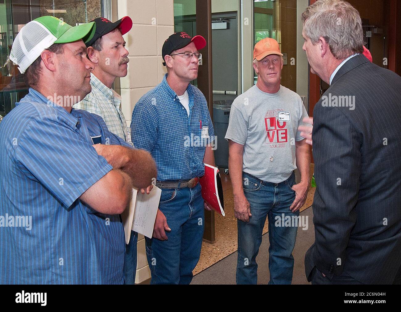 From left: Farmers Steve Roth, Done Rief, Dale Rief, Clifford Dilts discuss topics covered during a town hall meeting with Agriculture Secretary Tom Vilsack at the Glenwood Community High School in Glenwood, Iowa Thur., June 16, 2011. Farmers, local and regional media listened and questioned Secretary Vilsack on the cause of the floodwaters along the Missouri River affecting Iowa and Nebraska. Secretary Vilsack offered advice and assistance available through the United States Department of Agriculture and other federal agencies. Stock Photo