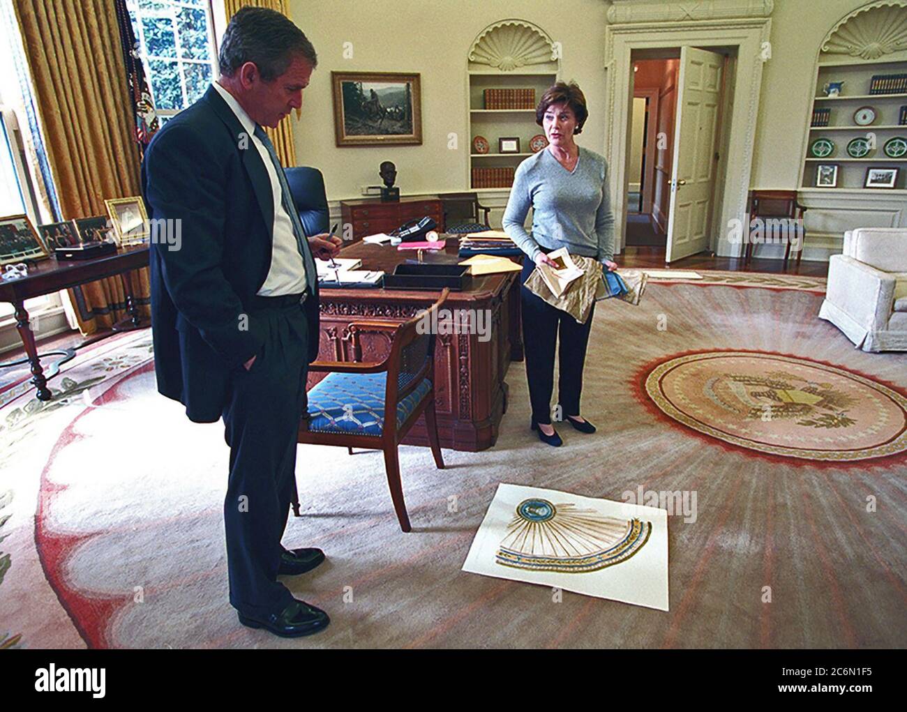 President W. Bush and Mrs. Laura Bush look at a design for the