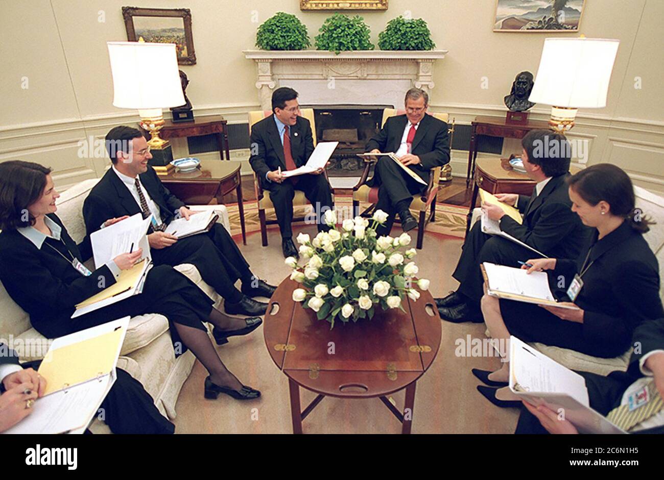President George W. Bush meets with White House Counsel Alberto Gonzales and staff Feb. 28, 2001 for a judicial selection meeting in the Oval Office. Participants include, from left: Andy Card, Courtney Elwood, Brad Berenson, Brett Kavanaugh, Helgi Walker and Tim Flanigan.  Photo by Eric Draper, Courtesy of the George W. Bush Presidential Library Stock Photo