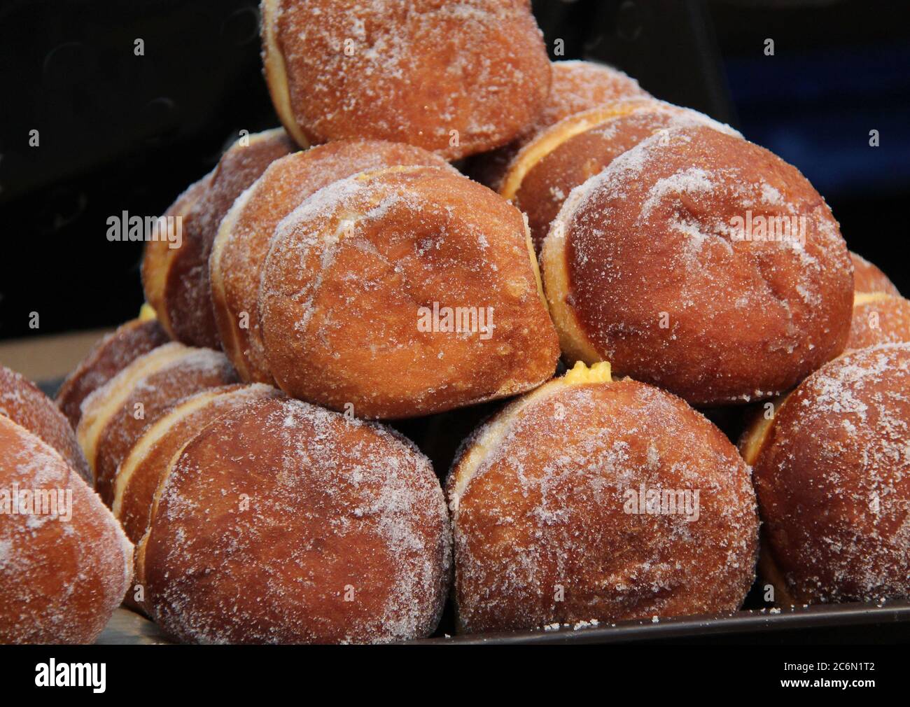 Display of Freshly Baked Sugar Coated Jam Doughnuts. Stock Photo