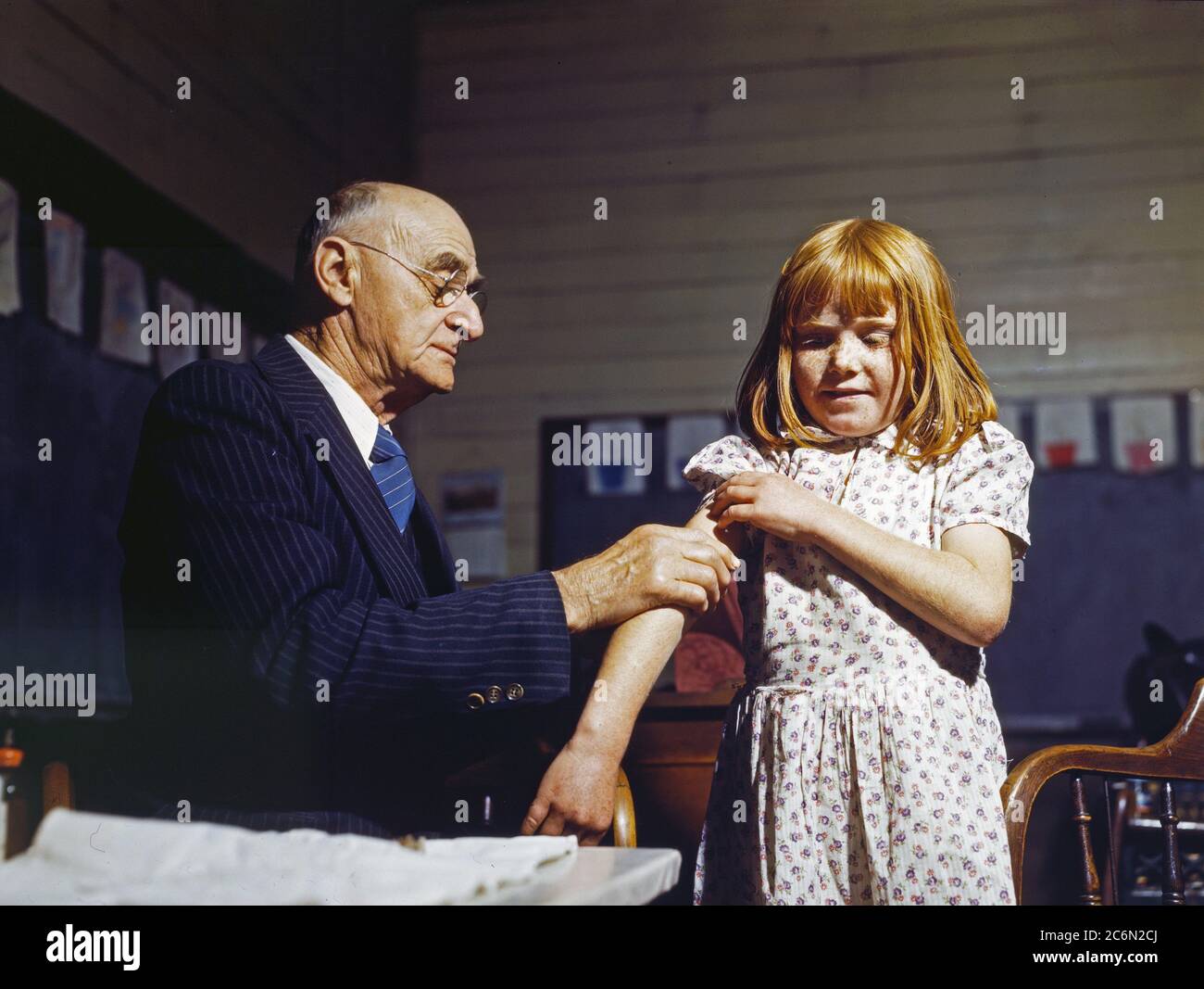 Dr. Schreiber of San Augustine giving a typhoid innoculation at a rural school, San Augustine County, Texas - April 1943 Stock Photo