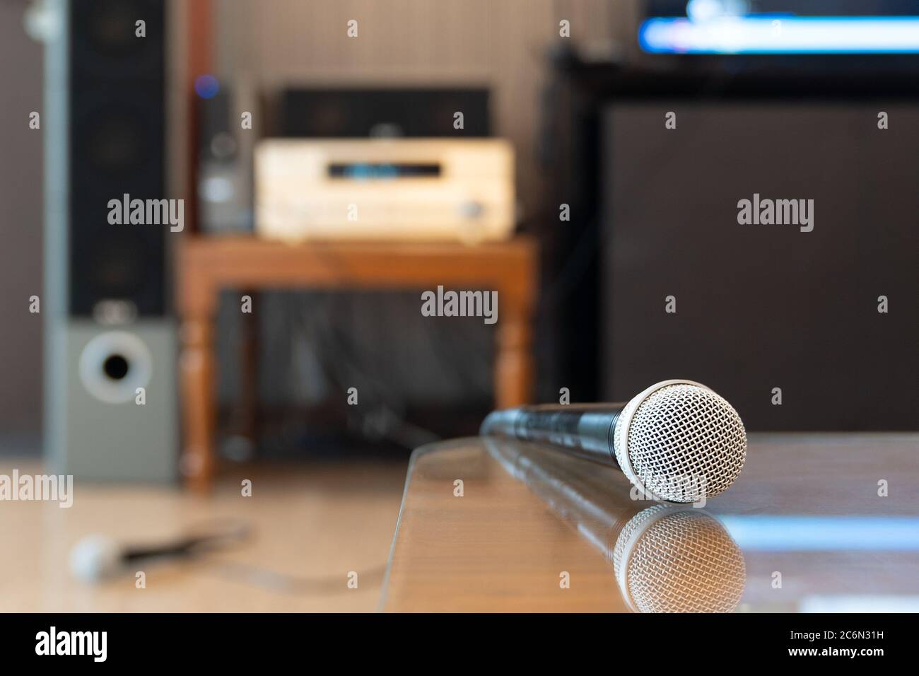 Modern microphone in karaoke room background. Close up. Stock Photo