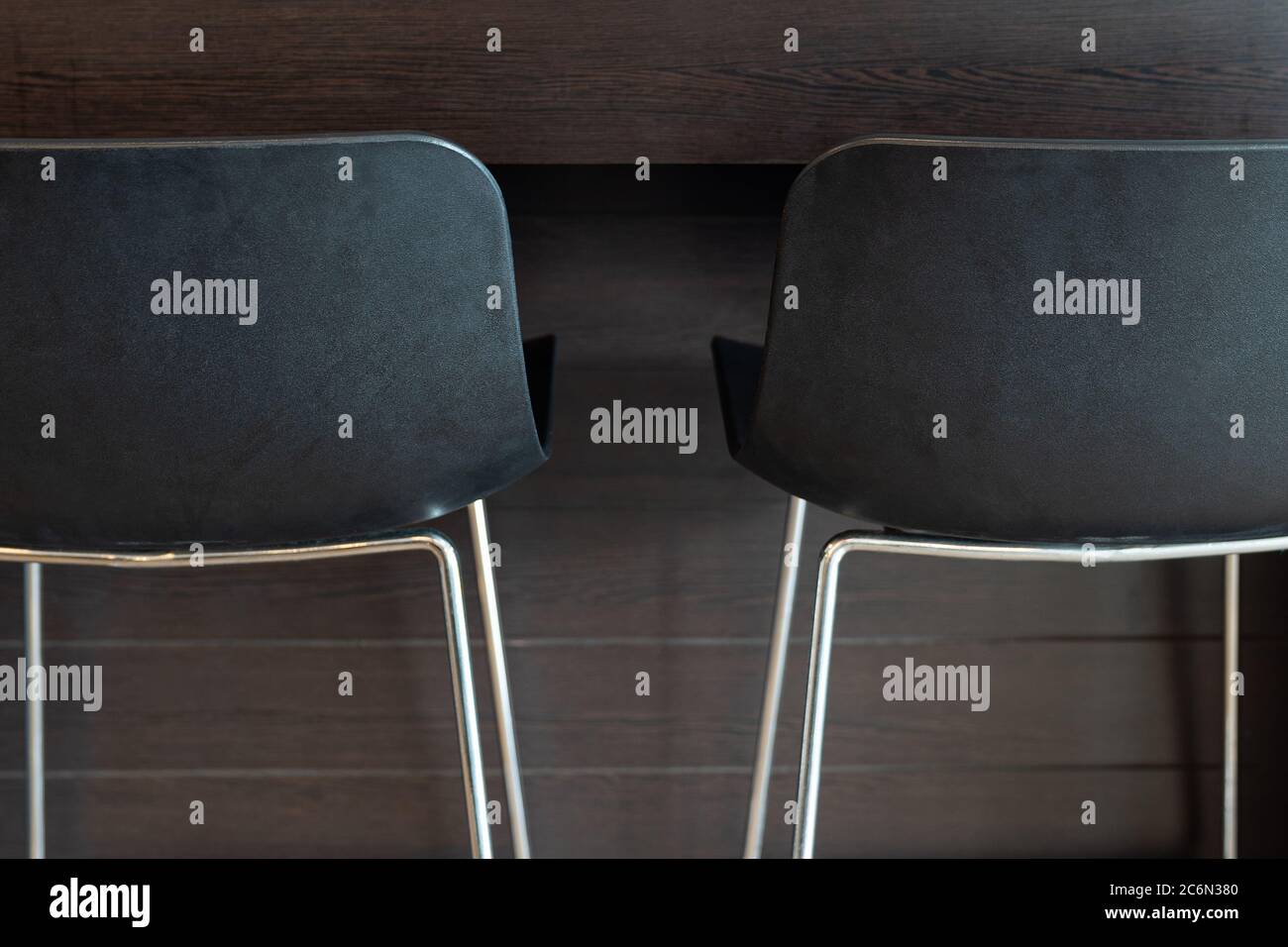 Close up. Black modern chairs on bar background. Stock Photo