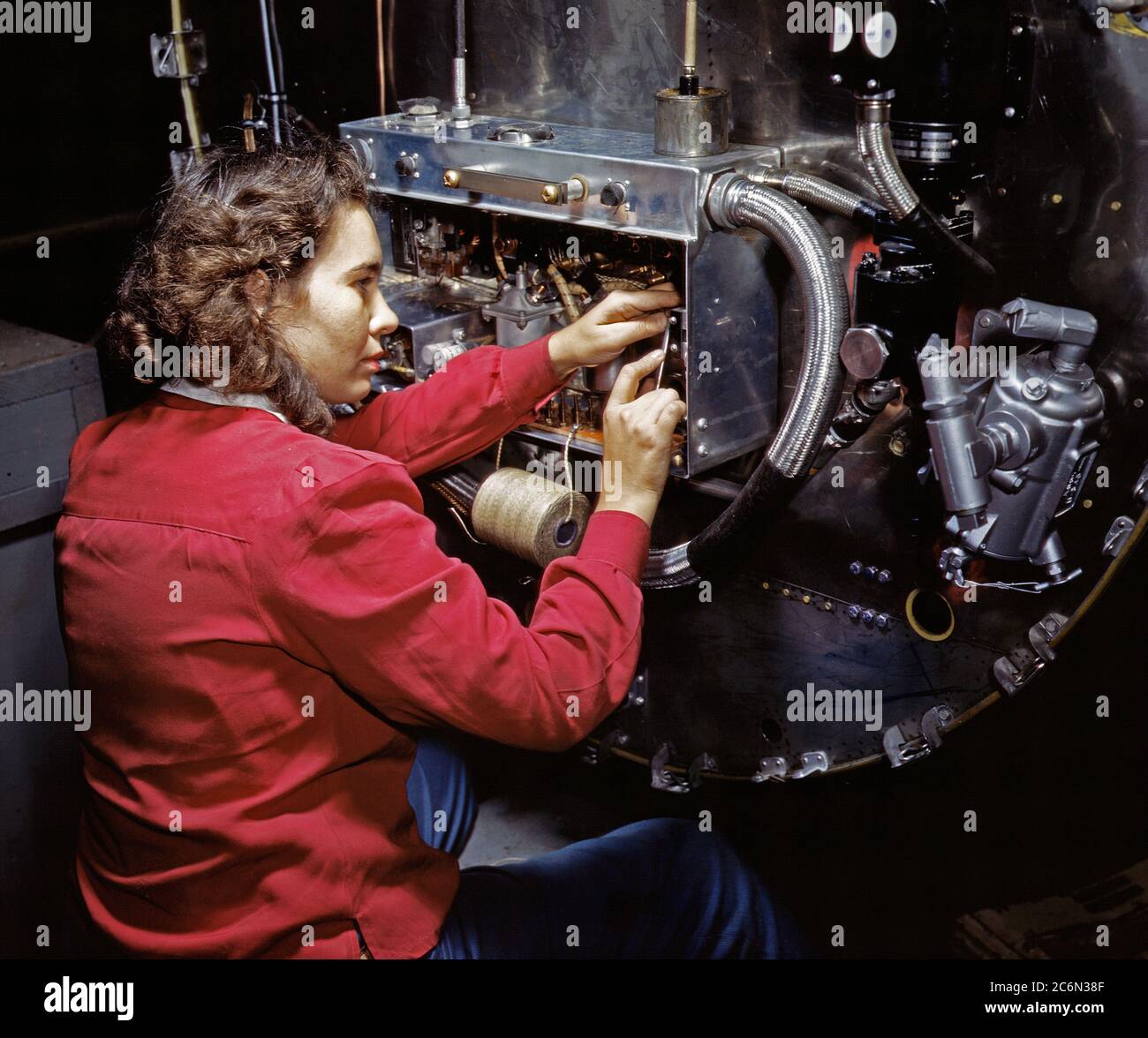 Switch boxes on the firewalls of B-25 bombers are assembled by women workers at North American [Aviation, Inc.]'s Inglewood, Calif., plant - October 1942 Stock Photo