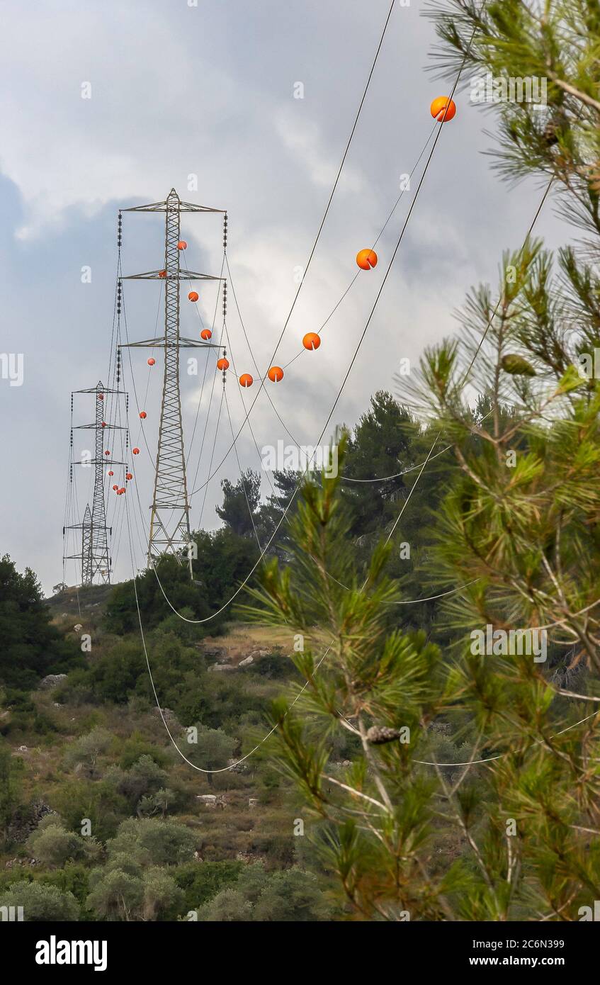 High voltage electric wires with orange spherical obstruction markers for  airplanes, in a forest near Jerusalem, Israel Stock Photo - Alamy
