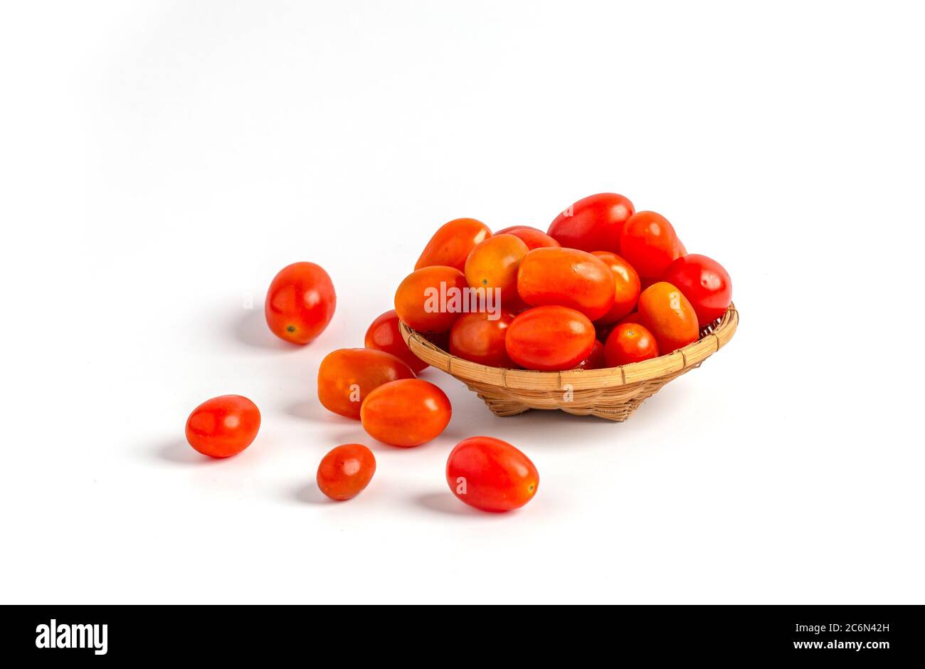 Red baby plum tomatoes in a basket isolated on white background Stock ...