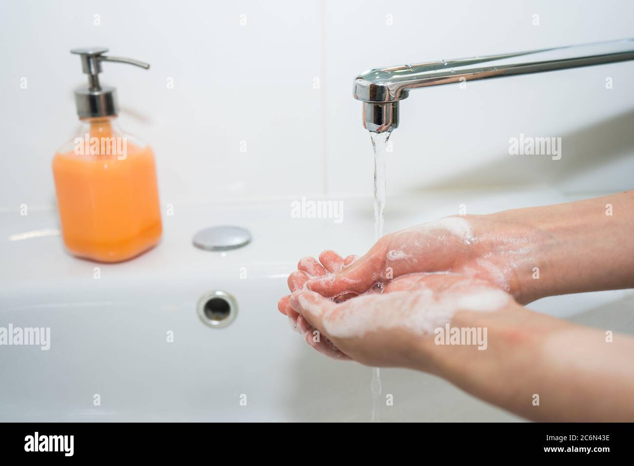 Hand washing with soap. Girl washes her hands with antibacterial soap  Stock Photo
