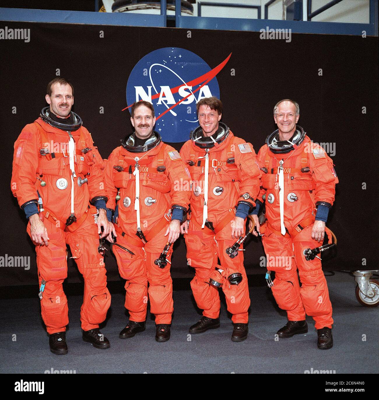 (24 May 1999) --- From the left, astronauts Steven L. Smith, John M. Grunsfeld, C. Michael Foale and Claude Nicollier, all mission specialists, pose for an informal portrait.  The STS-103 crew members are wearing training versions of the shuttle partial-pressure launch and entry space garments. Stock Photo