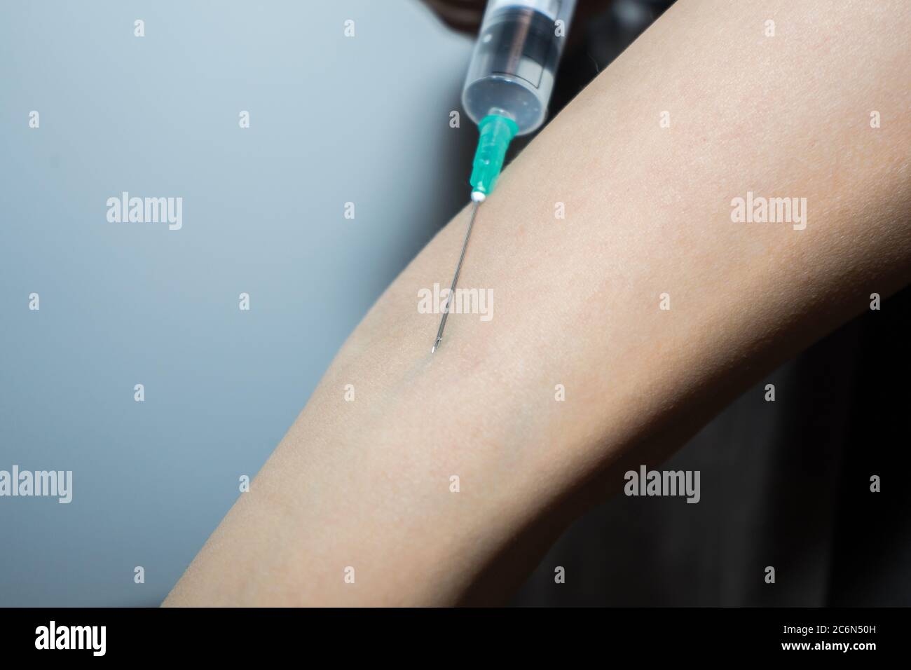 Inject Into A syringe enters the patient's vein. doctor makes an injection to the ...