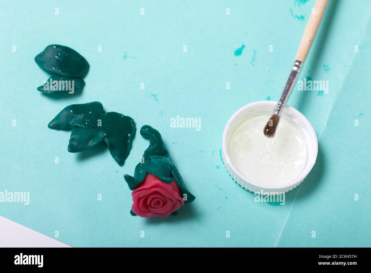 Roses with petals made of white polymer clay. Glue and brush. Crafts from  polymer clay Stock Photo - Alamy