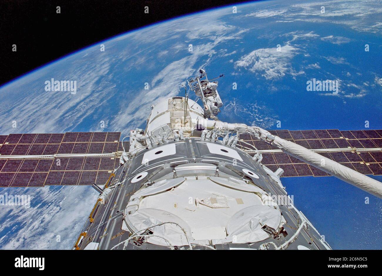 (4-15 December 1998) --- This photograph taken out the window of the Earth-orbiting Space Shuttle Endeavour shows the two astronaut spacewalkers, during one of three extravehicular activity (EVA) sessions, readying the recently-connected Russian-built FGB Module (Zarya) and the United States-built Unity Module (Node 1).  The two EVA astronauts are mission specialists James H. Newman (right)and Jerry L. Ross (lower left with red stripe on suit). Stock Photo