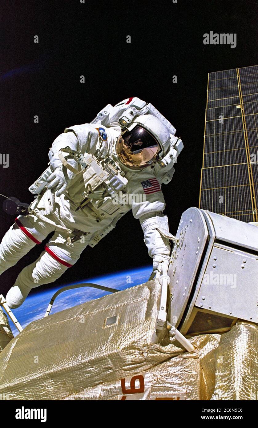 (4-15 Dec. 1998) --- Astronaut Jerry L. Ross, STS-88 mission specialist, is pictured during one of three space walks which were conducted on the eleven-day mission.  Perched on the end of Endeavour's remote manipulator system (RMS) arm, astronaut James H. Newman, mission specialist, recorded this image. Stock Photo