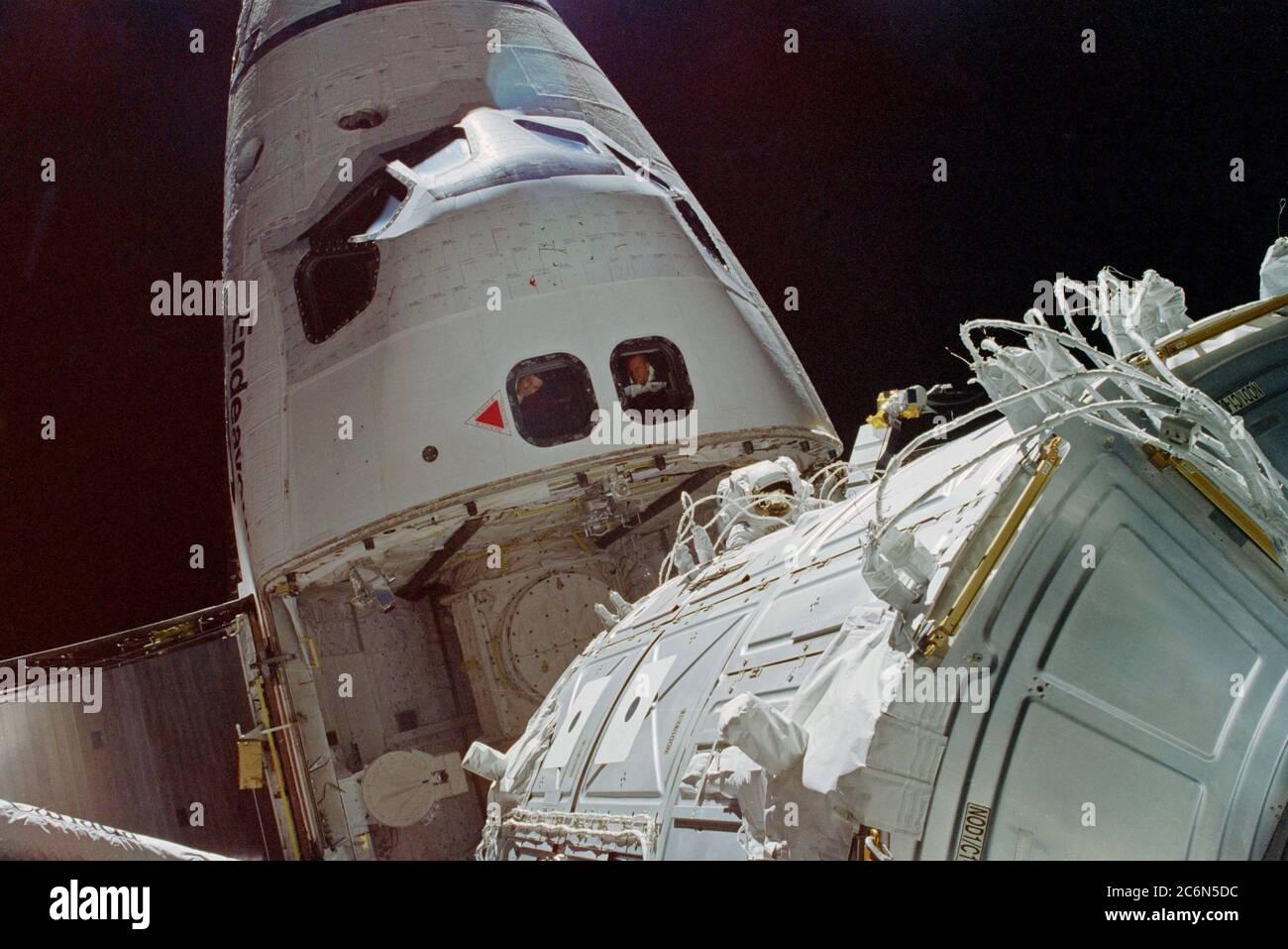 (4-15 Dec. 1998) --- This scene photographed from the top of Node 1 shows the nose of the Space Shuttle Endeavour, during one of three space walks.  Astronaut James H. Newman, mission specialist (frame center), was joined by astronaut Jerry L. Ross, mission specialist (out of frame), for the extravehicular activity (EVA) to ready for release the recently-joined Russian-built Zarya Module (FGB) and the United States-built Unity (Node 1) Module. Stock Photo