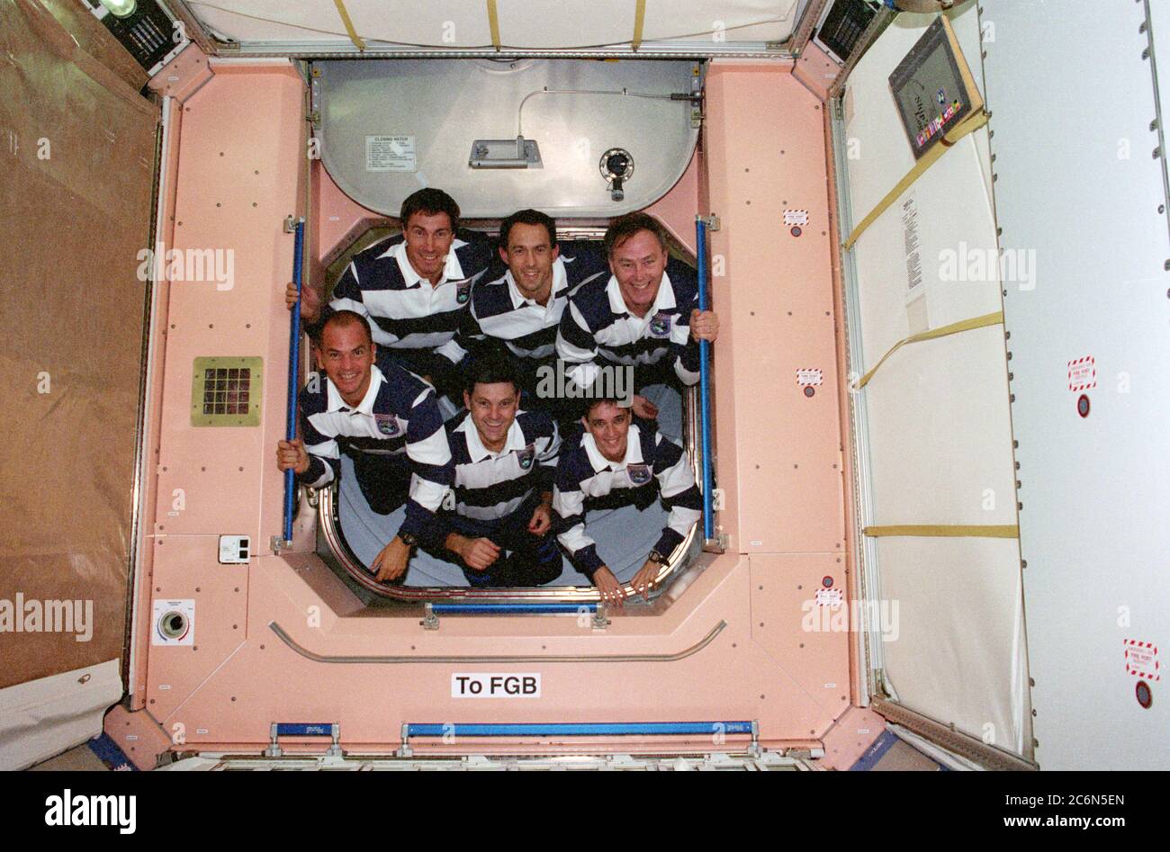 (4-15 Dec. 1998) --- The STS-88 crew members pose for the traditional inflight crew portrait in the U.S.-built Unity connecting module.  From left to right, bottom, are astronauts Frederick W. (Rick) Sturckow, pilot; Robert D. Cabana, mission commander; and Nancy  J. Currie, mission specialist.  Top row, cosmonaut Sergei K. Krikalev,  representing the Russian Space Agency, along with astronauts James H. Newman and Jerry L. Ross, all mission specialists. Stock Photo