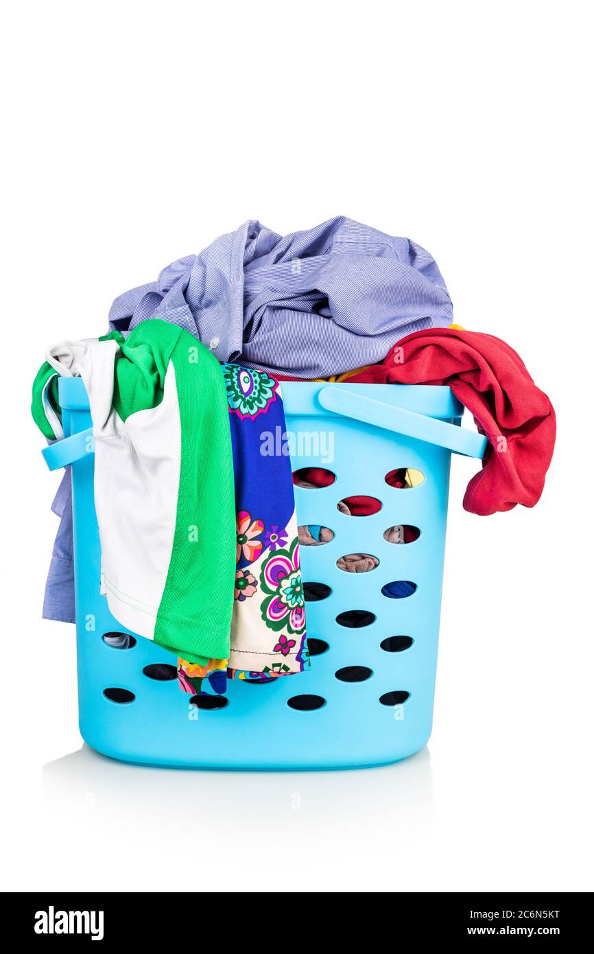 Laundry basket full of woman and man worn apparels for washing against white background Stock Photo