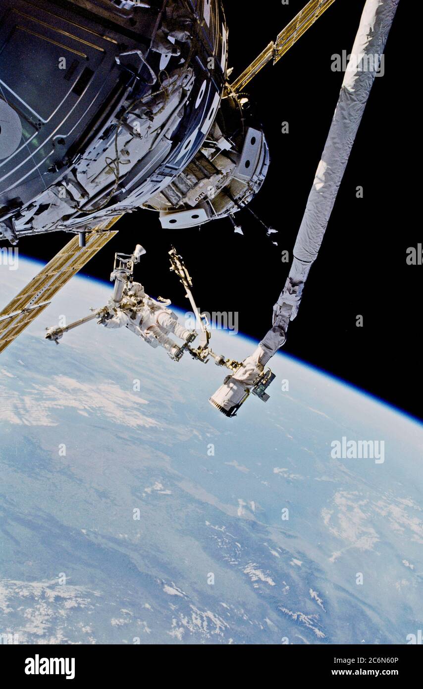 (30 May 1999) --- Astronaut Tamara E. Jernigan, mission specialist, is backdropped over the Aegean Sea as she handles the American-built crane which she helped to install on the International Space Station (ISS) during the May 30th space walk.  Jernigan's feet are anchored to a mobile foot restraint connected to the Space Shuttle Discovery's Canadian-built Remote Manipulator System (RMS). Stock Photo