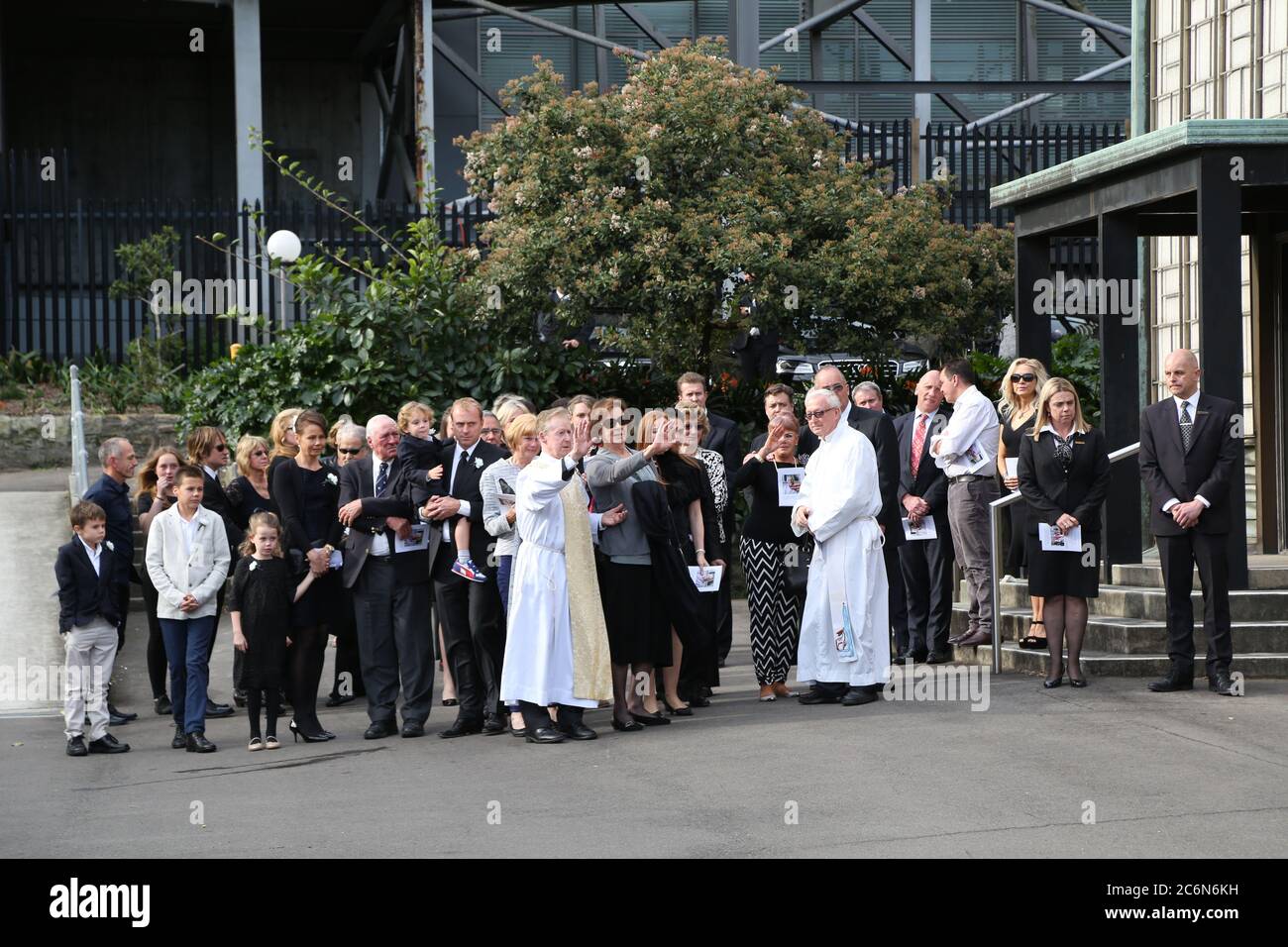 Funeral goers farewell the funeral car after the funeral of Dr Antony