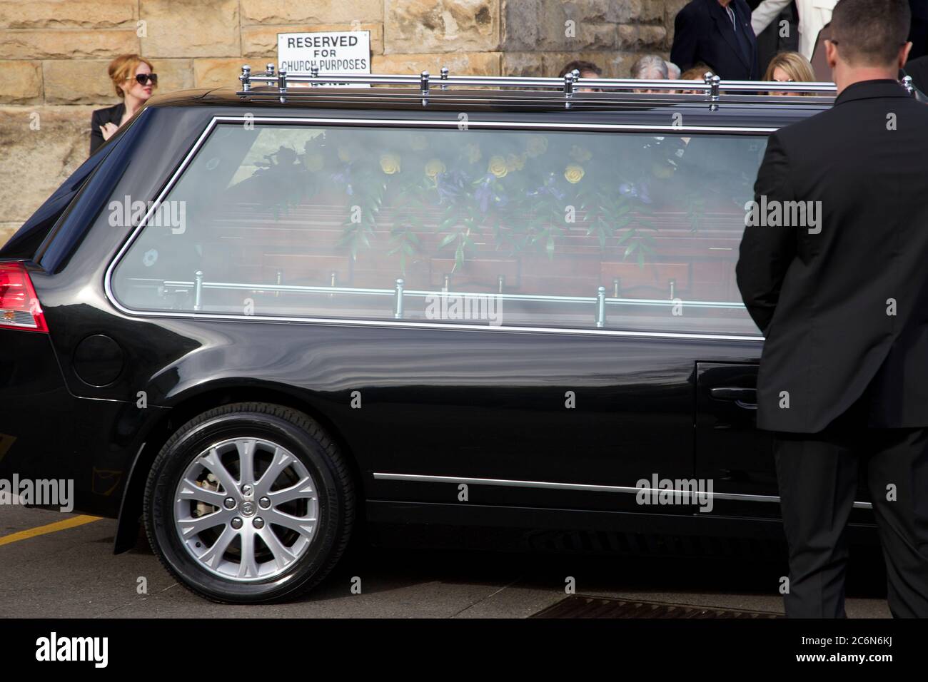 Funeral goers farewell the funeral car after the funeral of Dr Antony