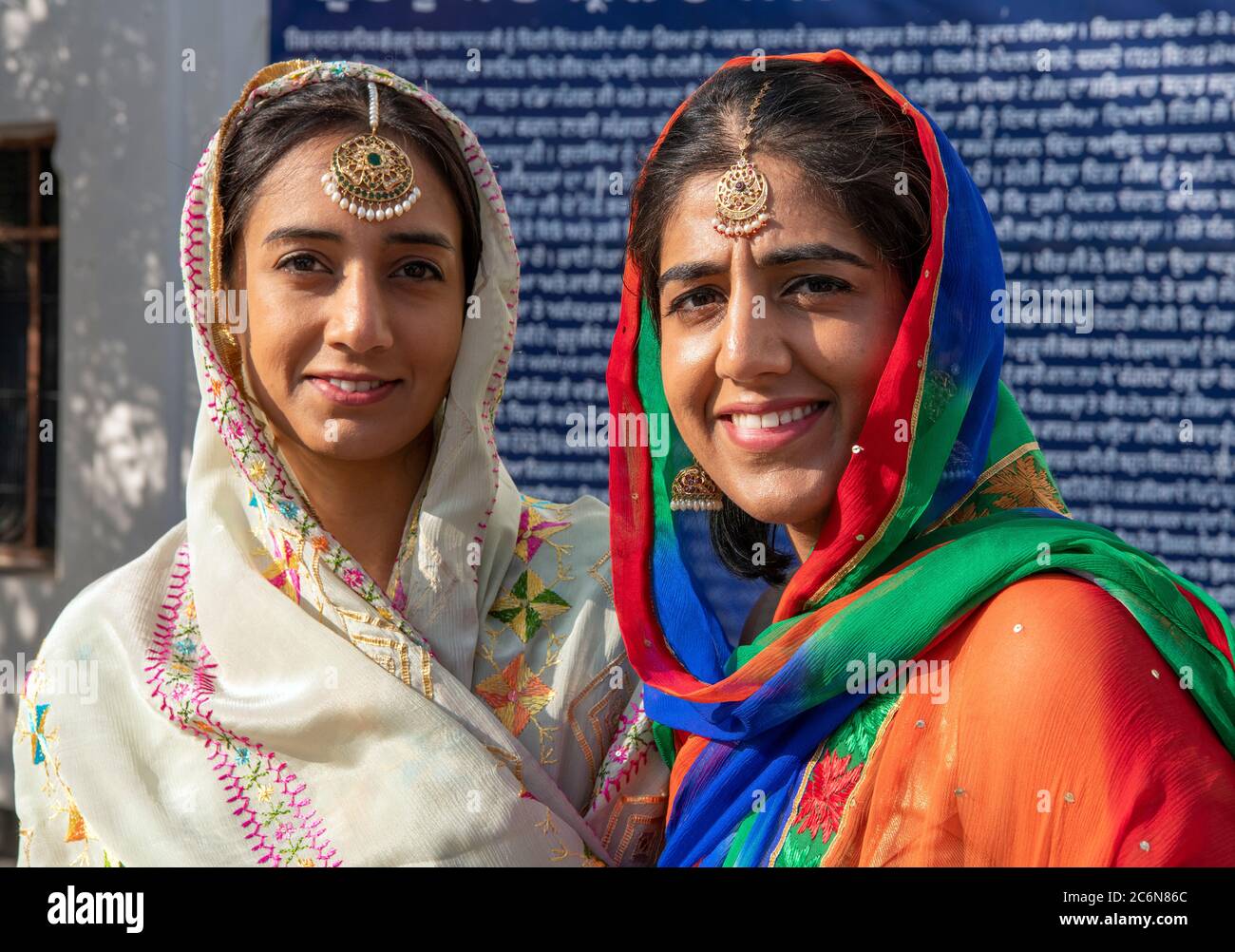 Two pretty Sikh wedding guests wearing traditional clothes and jewellery Punjab India Stock Photo