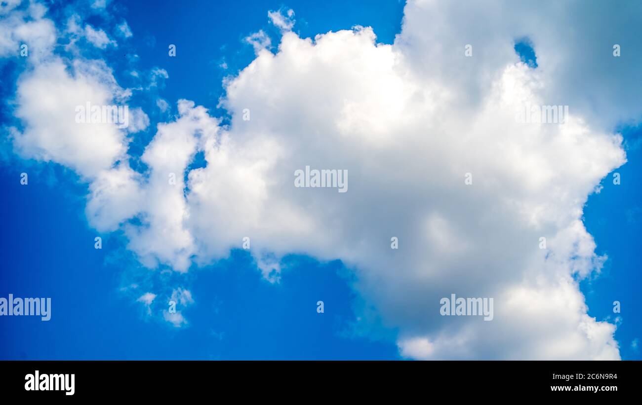 Background a sunny blue sky with the white clouds Stock Photo - Alamy