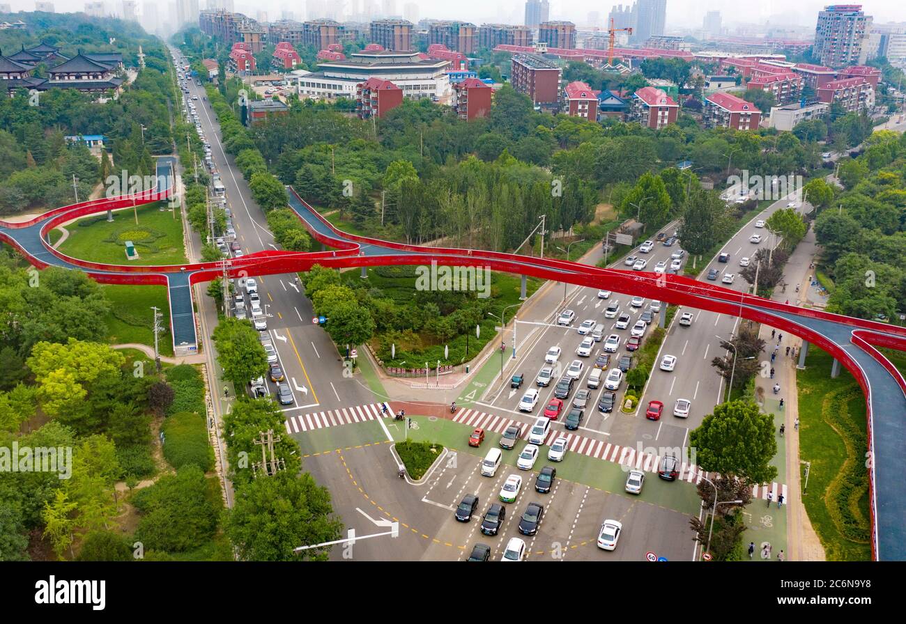 (200711) -- TANGSHAN, July 11, 2020 (Xinhua) -- Aerial photo taken on July 10, 2020 shows part of the 'green road' in Tangshan City, north China's Hebei Province. The first phase of a 'green road' project, including eight sight-seeing bridges and connecting several city gardens, has entered the trial operation stage. (Xinhua/Yang Shiyao) Stock Photo