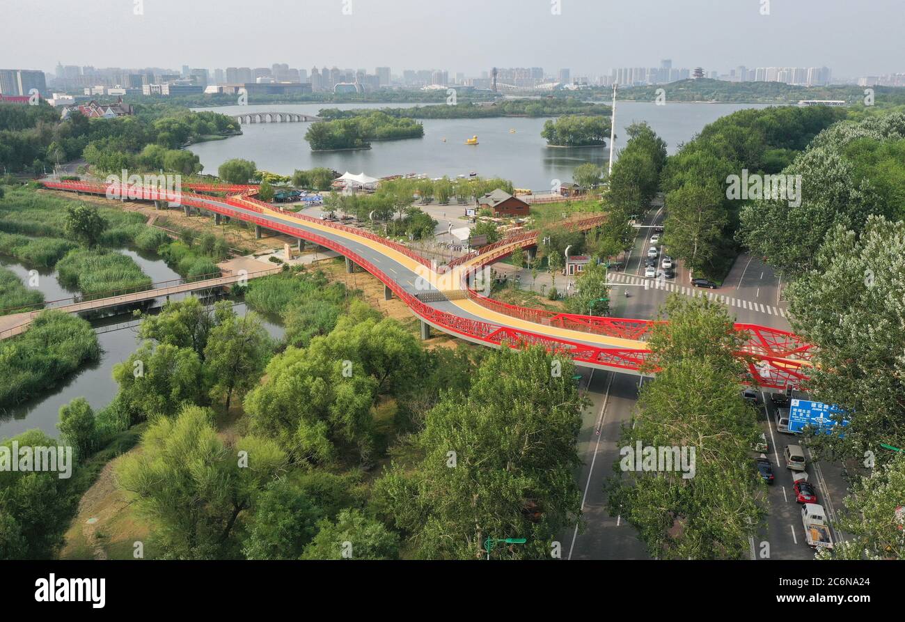 Tangshan. 10th July, 2020. Aerial photo taken on July 10, 2020 shows part of the 'green road' in Tangshan City, north China's Hebei Province. The first phase of a 'green road' project, including eight sight-seeing bridges and connecting several city gardens, has entered the trial operation stage. Credit: Yang Shiyao/Xinhua/Alamy Live News Stock Photo