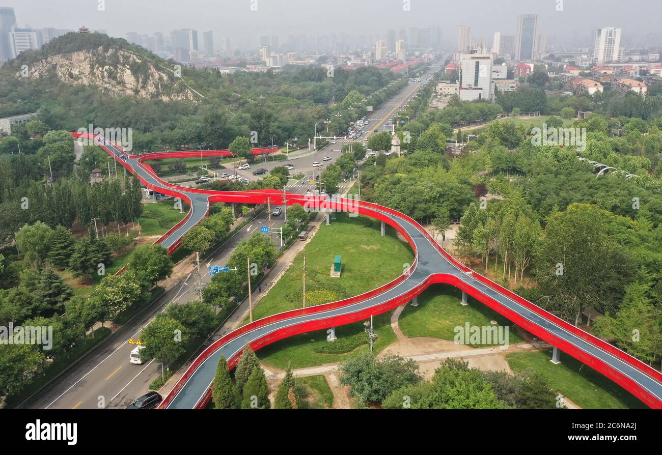 Tangshan. 11th July, 2020. Aerial photo taken on July 11, 2020 shows part of the 'green road' in Tangshan City, north China's Hebei Province. The first phase of a 'green road' project, including eight sight-seeing bridges and connecting several city gardens, has entered the trial operation stage. Credit: Yang Shiyao/Xinhua/Alamy Live News Stock Photo