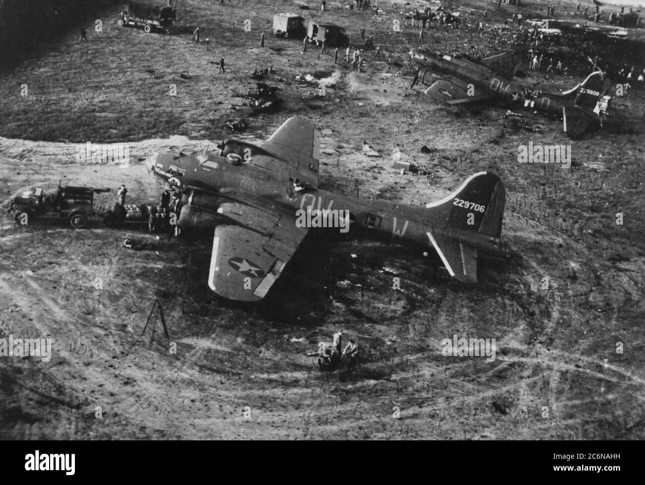 Two of the B-17 Flying Fortresses that were damaged by an explosion at RAF Alconbury May 27, 1943, sit on the flightline. Nineteen U.S. Army Air Force 95th Bombardment Group airmen were killed and 21 others were injured when a 500-pound bomb detonated on the flightline. A memorial plaque was placed in their honor at Alconbury Airfield May 27, 2013. Stock Photo