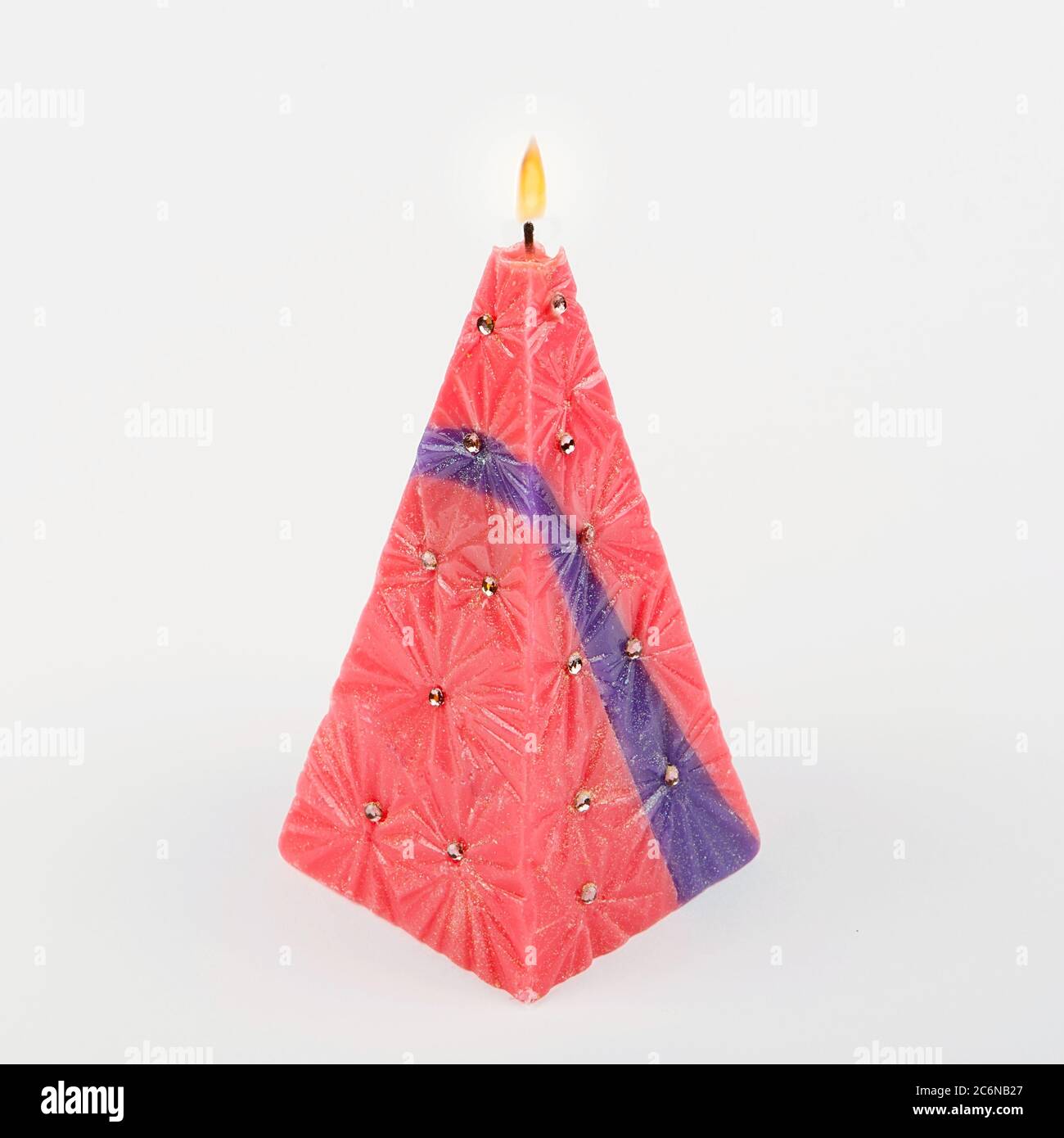 Decorative Handmade candle in the shape of a pyramid on white background Stock Photo