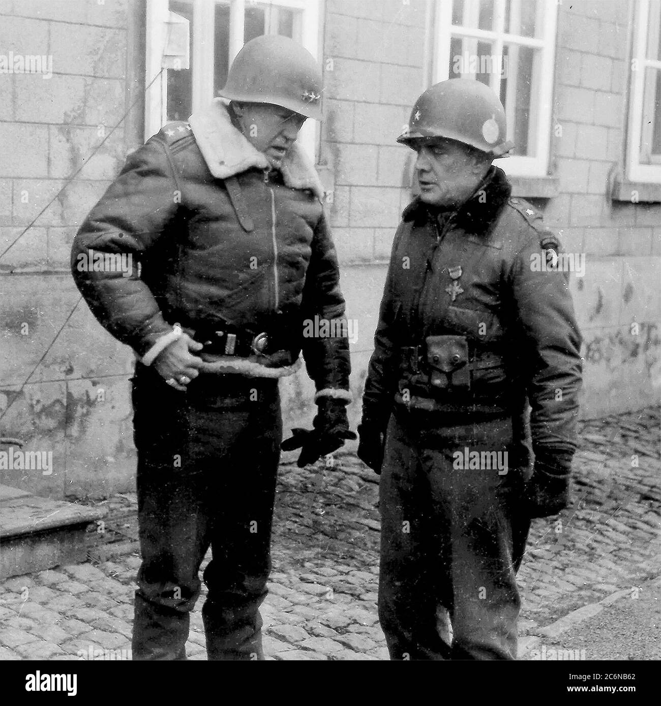 Lt. Gen. George S. Patton speaks to Brig. Gen. Anthony McAuliffe, January 1945. Patton led the Third Army in a sweep across France and an instrumental role in defeating the German counter offensive in the Ardennes. Patton commanded the Third Army from 1944 to 1945. Third Army’s unit motto “Patton’s Own – Third, Always First” is in honor of Patton. (U.S. Army photo/Released) Stock Photo