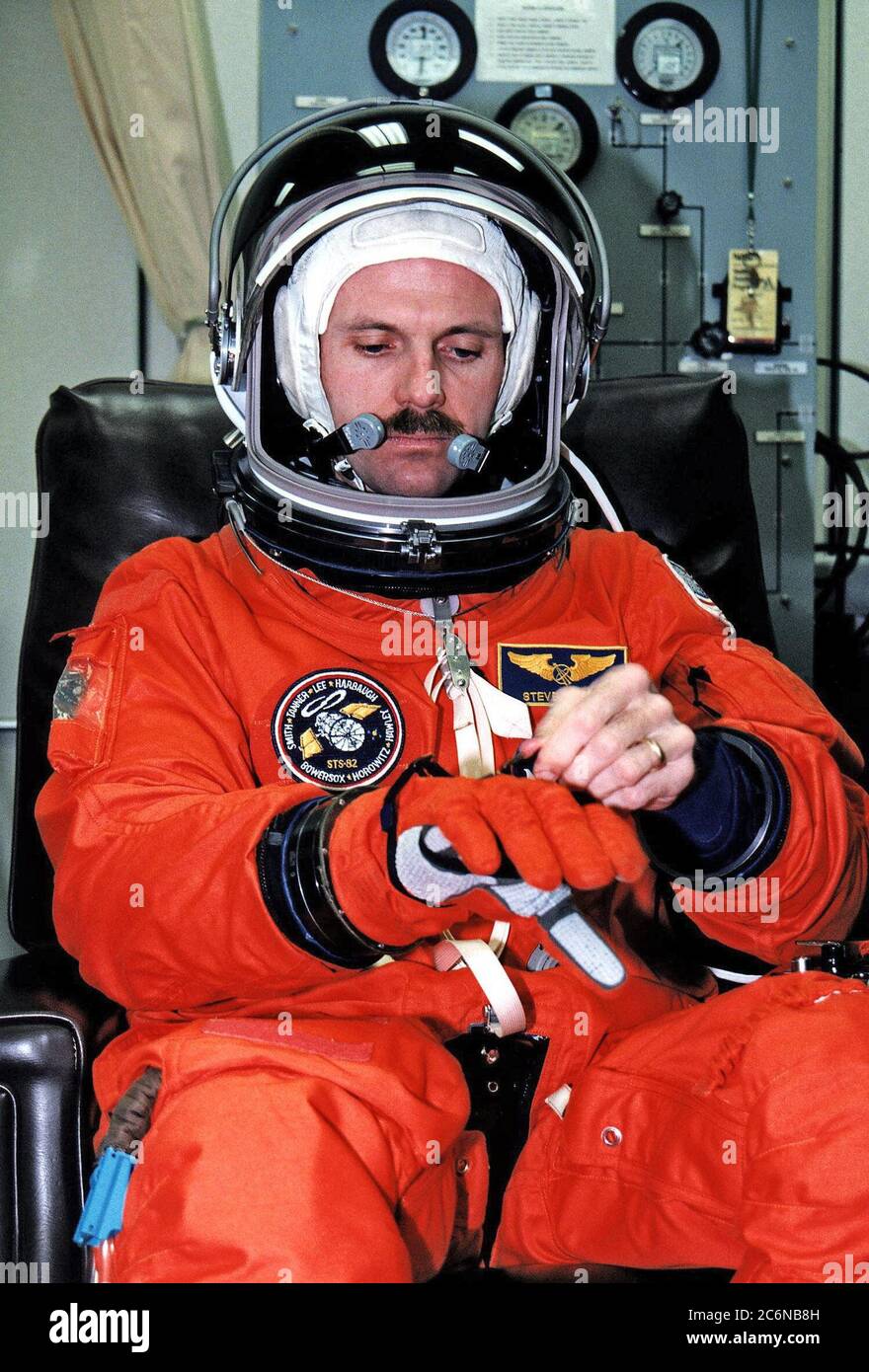 STS-82 Mission Specialist Steven L. Smith adjusts the glove of his launch and entry space suit during a practice countdown at KSC. Smith and the other six STS-82 crew members are at KSC to participate in the Terminal Countdown Demonstration Test (TCDT), a dress rehearsal for launch. STS-82 will be the second Hubble Space Telescope servicing mission. Liftoff is targeted for Feb. 11 Stock Photo