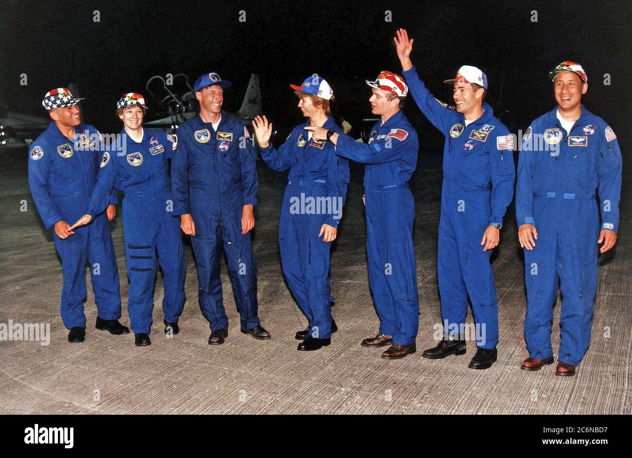 STS-84 crew members greet press representatives and other onlookers after their arrival at KSC’s Shuttle Landing Facility Sunday evening (May 12, 1997), about an hour before the countdown clock will begin ticking toward the scheduled May 15 launch of the Space Shuttle Atlantis on Mission STS-84. From left, are Mission Specialist Carlos I. Noriega, Pilot Eileen Marie Collins, Mission Specialist C. Michael Foale, Mission Specialist Elena V. Kondakova of the Russian Space Agency, Commander Charles J. Precourt, Mission Specialist Jean-Francois Clervoy of the European Space Agency, and Mission Spec Stock Photo