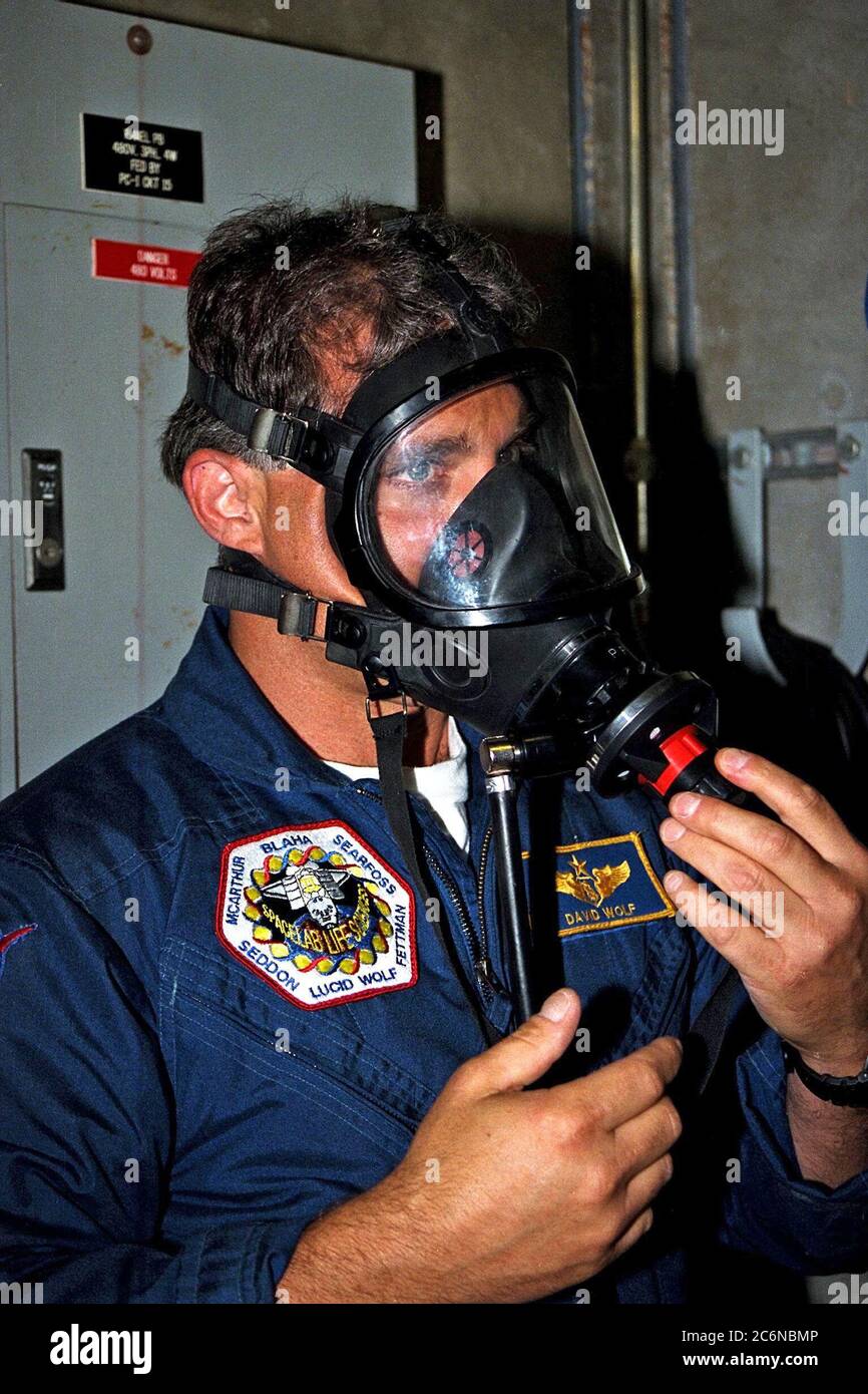 STS-86 Mission Specialist David Wolf dons a gas mask as part of training exercises during the Terminal Countdown Demonstration Test (TCDT), a dress rehearsal for launch. Wolf is wearing the patch from his first and only mission to date, STS-58 in 1993. Stock Photo