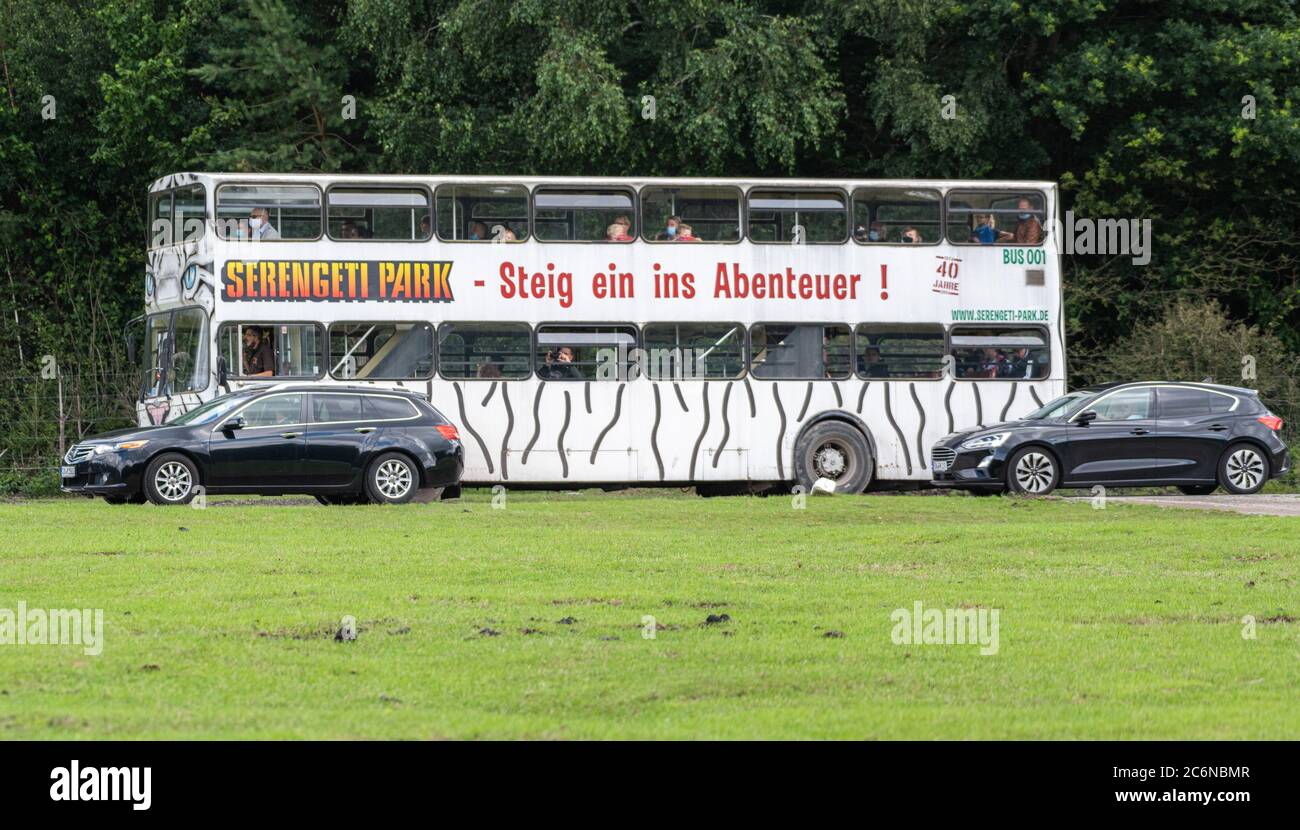11 July 2020, Lower Saxony, Hodenhagen: Visitor vehicles and a visitor bus drive through the Serengeti-Park Hodenhagen. (to dpa 'How business has started again in the amusement parks in Lower Saxony'). Photo: Mohssen Assanimoghaddam/dpa Stock Photo