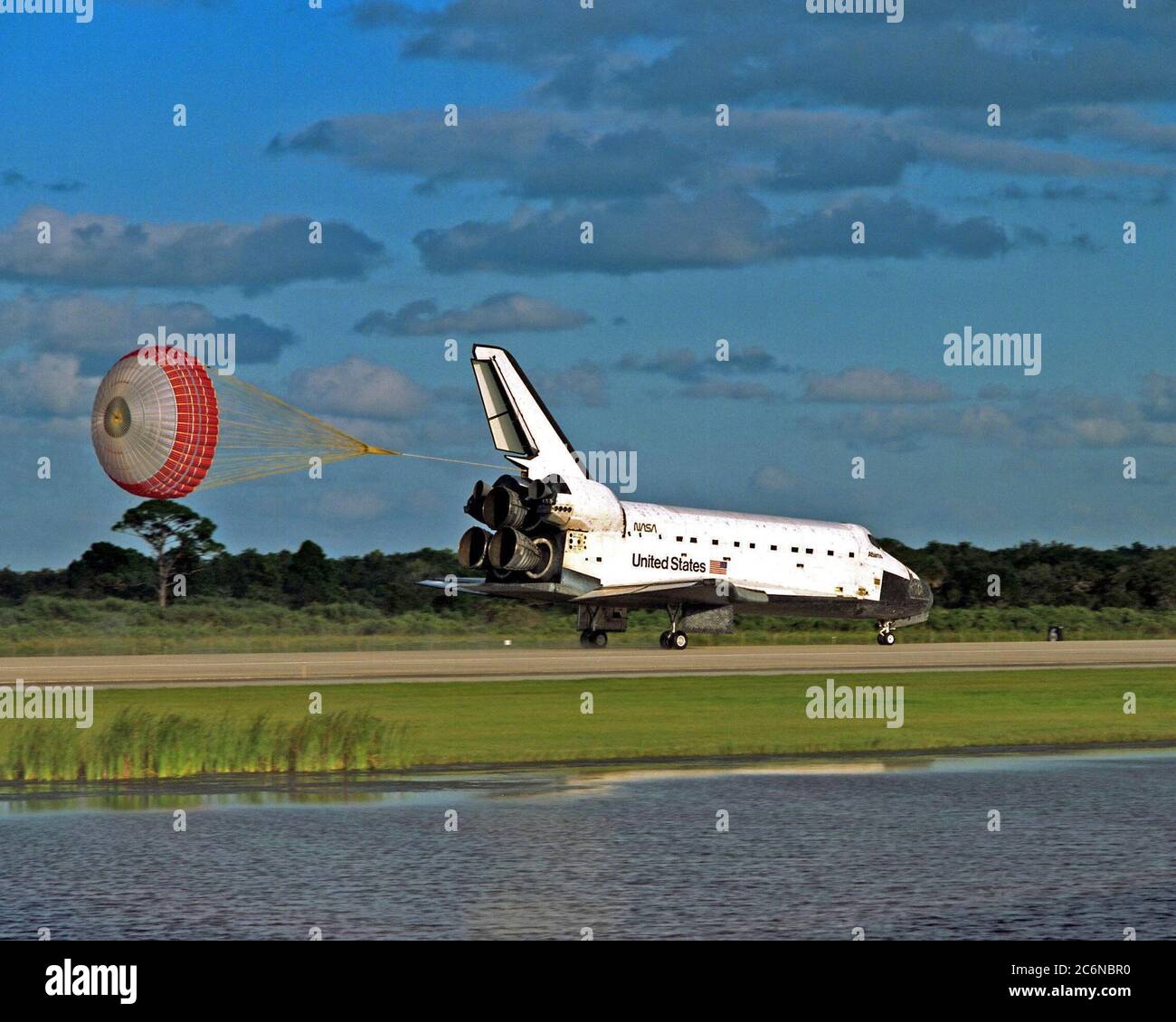 KENNEDY SPACE CENTER, Fla. -- The orbiter drag chute deploys after the Space Shuttle orbiter Atlantis lands on Runway 15 of the KSC Shuttle Landing Facility (SLF) at the conclusion of the nearly 11-day STS-86 mission. Main gear touchdown was at 5:55:09 p.m. EDT, Oct. 6, 1997, with an unofficial mission-elapsed time of 10 days, 19 hours, 20 minutes and 50 seconds. The first two KSC landing opportunities on Sunday were waved off because of weather concerns. The 87th Space Shuttle mission was the 40th landing of the Shuttle at KSC. On Sunday evening, the Space Shuttle program reached a milestone: Stock Photo
