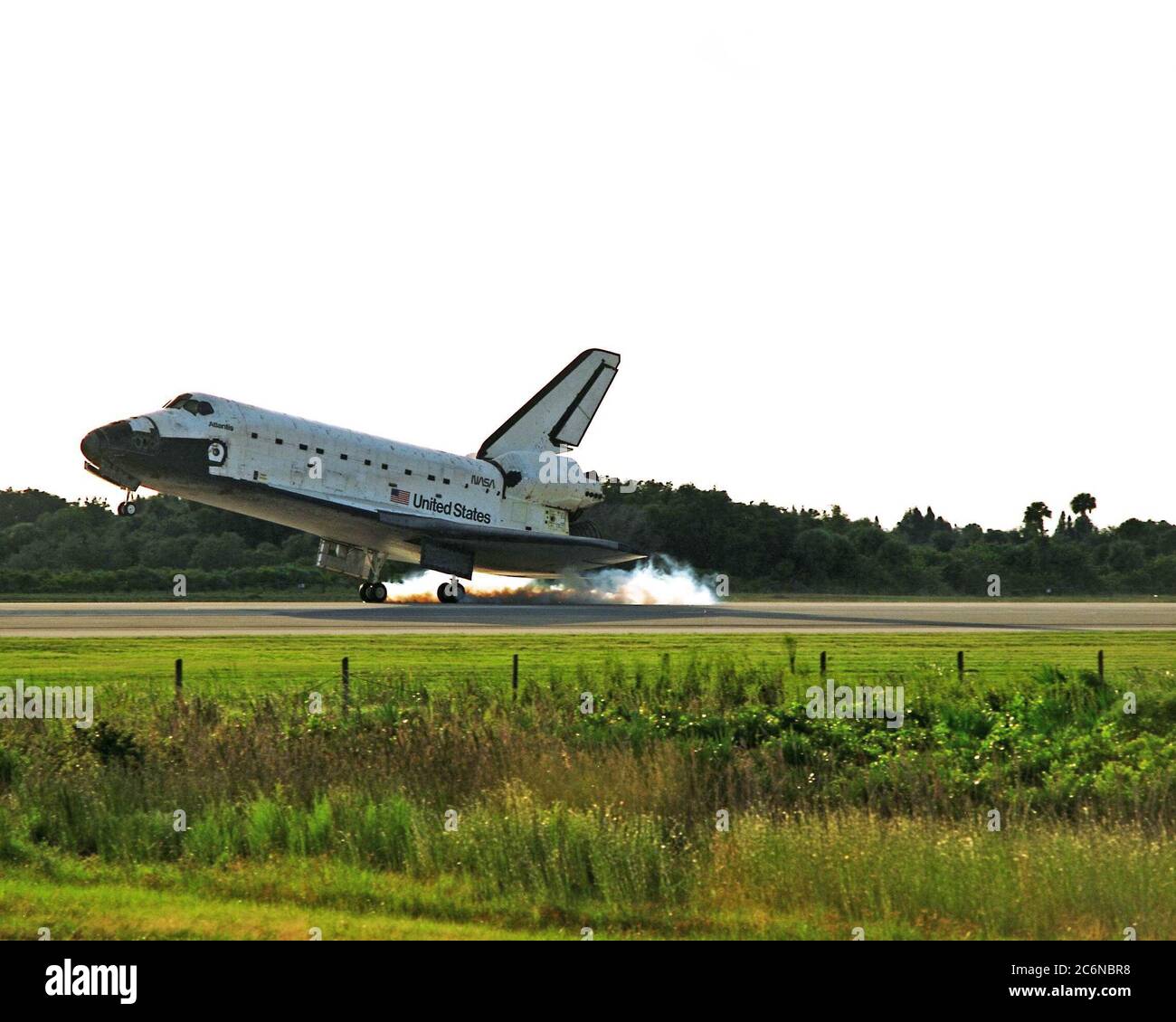 KENNEDY SPACE CENTER, Fla. -- The Space Shuttle orbiter Atlantis touches down on Runway 15 of the KSC Shuttle Landing Facility (SLF) to complete the nearly 11-day STS-86 mission. Main gear touchdown was at 5:55:09 p.m. EDT on Oct. 6, 1997. The unofficial mission-elapsed time at main gear touchdown was 10 days, 19 hours, 20 minutes and 50 seconds. The first two landing opportunities on Sunday were waved off because of weather concerns. The 87th Space Shuttle mission was the 40th landing of the Shuttle at KSC. On Sunday evening, the Space Shuttle program reached a milestone: The total flight tim Stock Photo