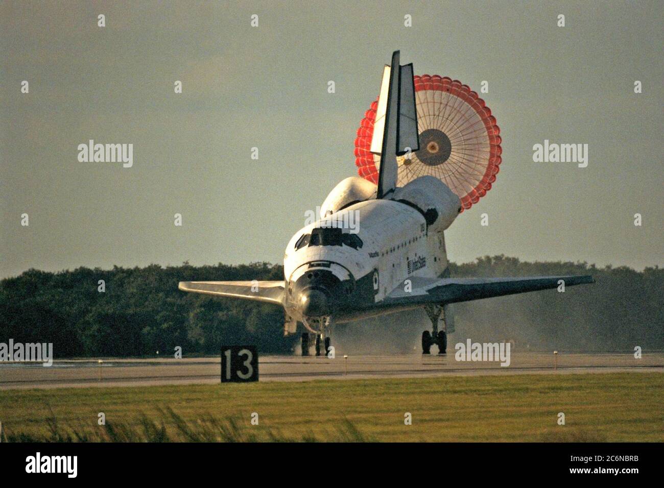 KENNEDY SPACE CENTER, Fla. -- The orbiter drag chute deploys after the Space Shuttle orbiter Atlantis lands on Runway 15 of the KSC Shuttle Landing Facility (SLF) at the conclusion of the nearly 11-day STS-86 mission. Main gear touchdown was at 5:55:09 p.m. EDT, Oct. 6, 1997, with an unofficial mission-elapsed time of 10 days, 19 hours, 20 minutes and 50 seconds. The first two KSC landing opportunities on Sunday were waved off because of weather concerns. The 87th Space Shuttle mission was the 40th landing of the Shuttle at KSC. On Sunday evening, the Space Shuttle program reached a milestone: Stock Photo