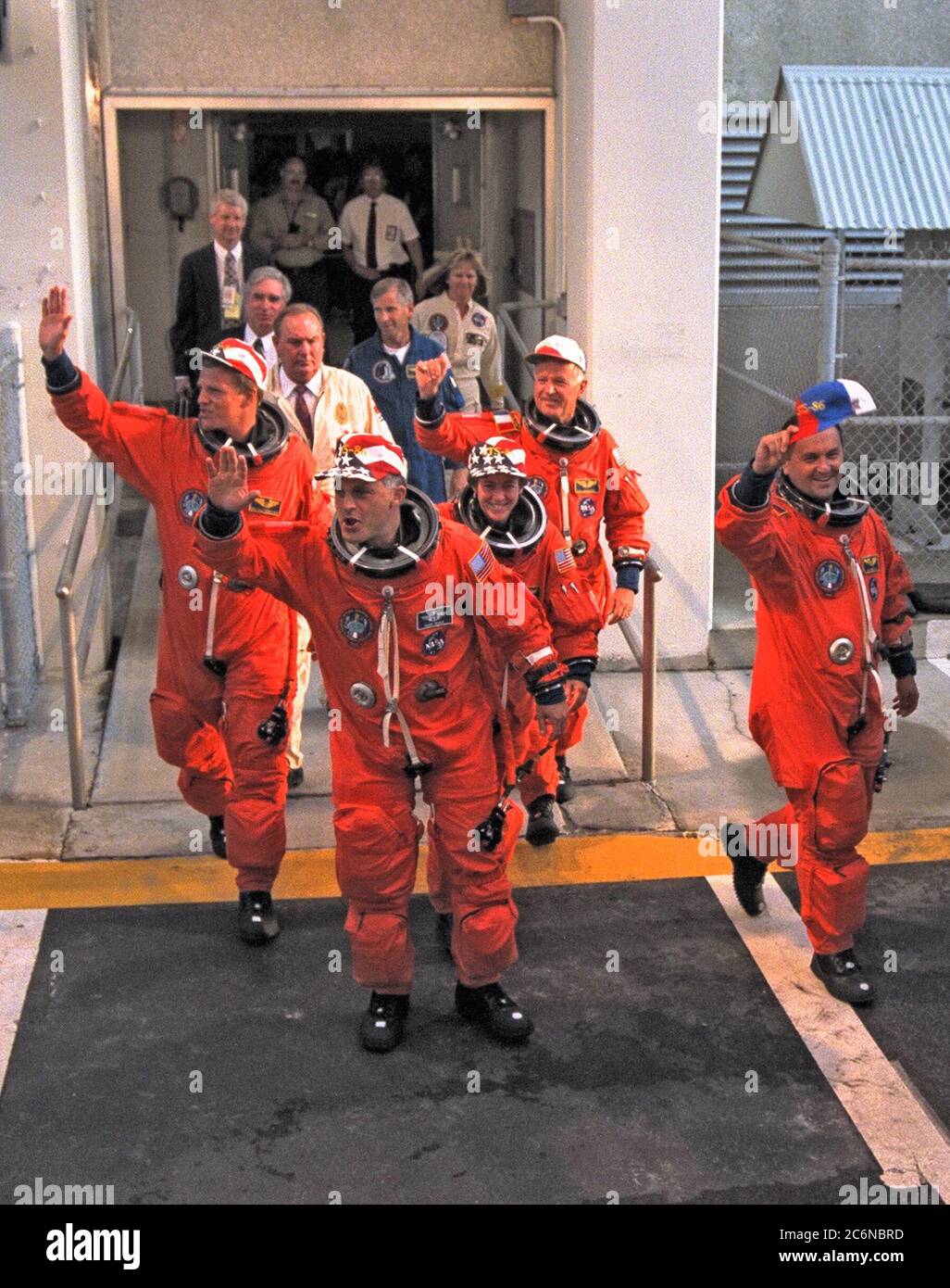 The five STS-86 mission specialists wave to the crowd of press representatives, KSC employees and other well-wishers as they depart from the Operations and Checkout Building. The three U.S. mission specialists (and their nicknames for this flight) are, from left, 'too tall' Scott E. Parazynski, 'just right' David A. Wolf and 'too short' Wendy B. Lawrence. The two mission specialists representing foreign space agencies are Vladimir Georgievich Titov of the Russian Space Agency, in foreground at right, and Jean-Loup J.M. Chretien of the French Space Agency, CNES, in background at right. Commande Stock Photo