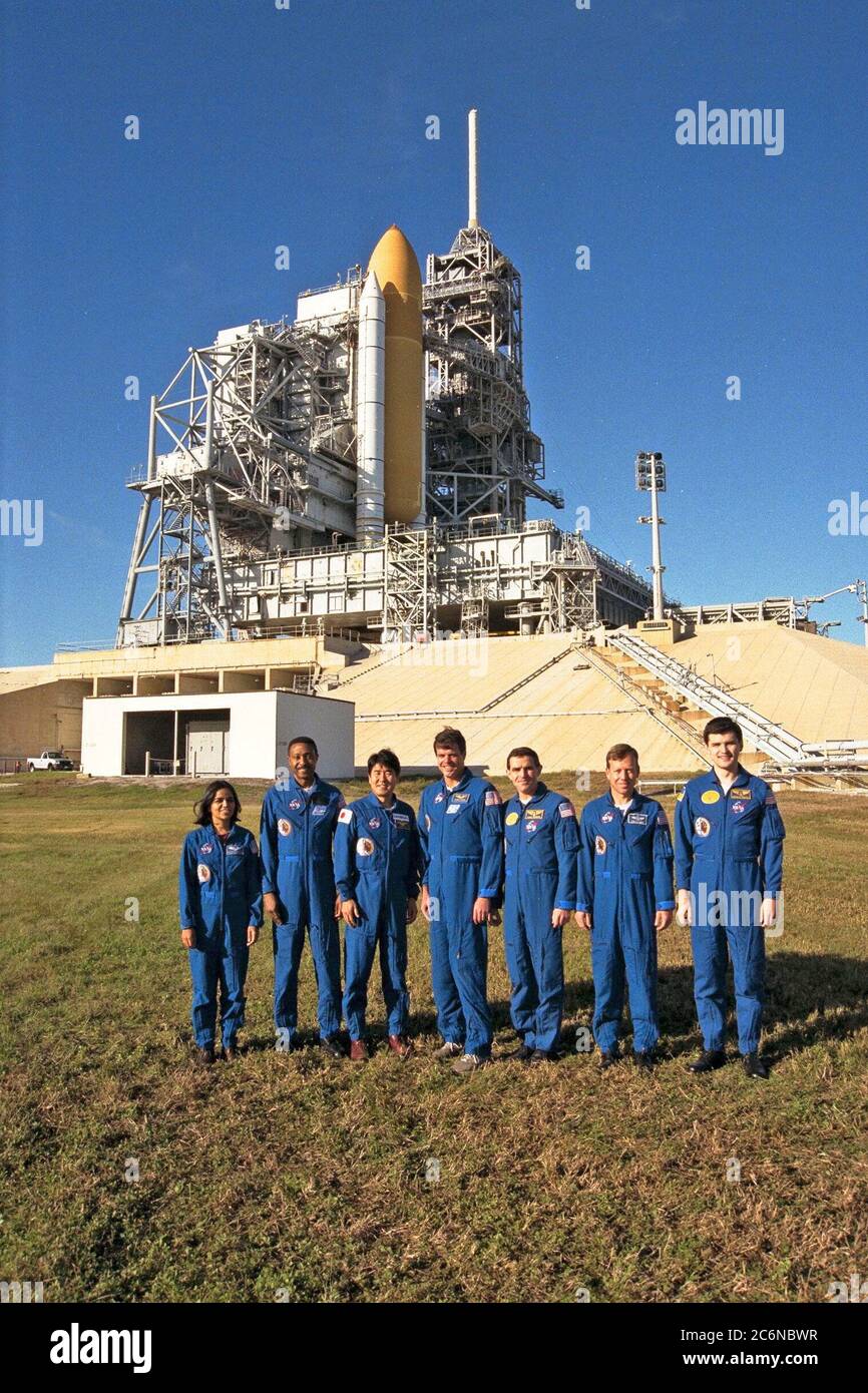 The crew of the STS-87 mission, scheduled for launch Nov. 19 aboard the Space Shuttle Columbia from Pad 39B at Kennedy Space Center (KSC), participate in the Terminal Countdown Demonstration Test (TCDT) at KSC. Posing for a group shot by Pad 39B are, from left to right, Mission Specialist Kalpana Chawla, Ph.D.; Mission Specialist Winston Scott; Mission Specialist Takao Doi, Ph.D., of the National Space Development Agency of Japan; Commander Kevin Kregel; Payload Specialist Leonid Kadenyuk of the National Space Agency of Ukraine (NSAU); Pilot Steven Lindsey; and Kadenyuk’s back-up, Yaroslav Pus Stock Photo