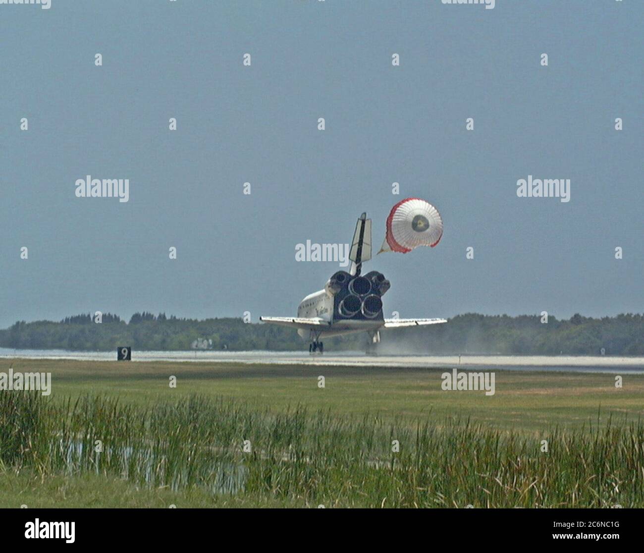 KENNEDY SPACE CENTER, FLA. -- With its drag chute deployed, the orbiter Discovery touches down on Runway 15 of KSC's Shuttle Landing Facility to complete the STS-91 mission. Main gear touchdown was at 2:00:18 p.m. EDT on June 12, 1998, landing on orbit 155 of the mission. The wheels stopped at 2:01:22 p.m. EDT, for a total mission-elapsed time of 9 days, 19 hours, 55 minutes and 1 second. Stock Photo