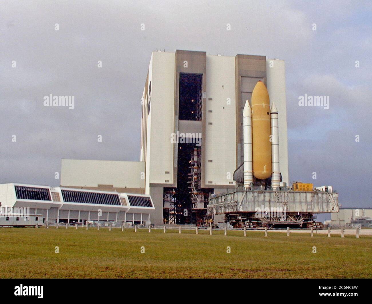 Towering atop the mobile launcher platform and crawler transporter, Space Shuttle Discovery rolls out of the Vehicle Assembly Building on its way to Launch Pad 39B which is 4.2 miles (6.8 kilometers) away. While at the pad, the orbiter, external tank and solid rocket boosters will undergo final preparations for the STS-103 launch targeted for Dec. 6, 1999, at 2:37 a.m. EST. Stock Photo