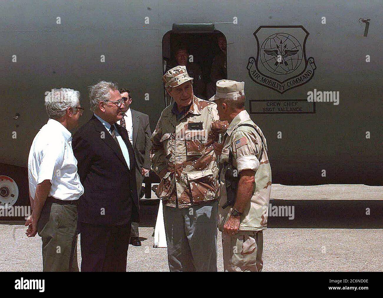 President George Bush is escorted from a US Air Force C-141 Starlifter by Gen. Robert B. Johnston, commander Joint Task Force.  The President arrived in Somalia at 1250 local time for a New Year's Eve holiday visit with troops Stock Photo