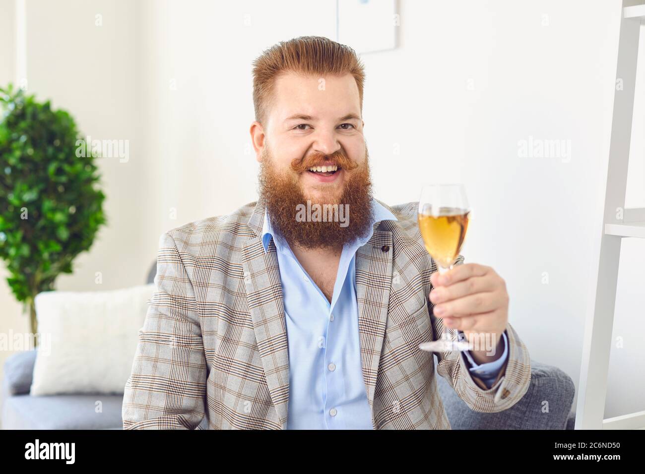 Online dating. Funny fat man with glass of wine having romantic talk to his  girlfriend on webcam from home Stock Photo - Alamy