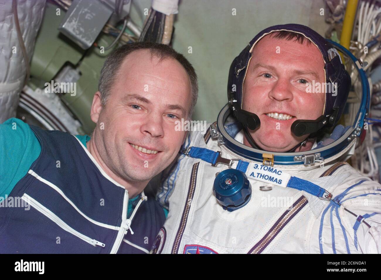 (26 Jan 1998) --- This Electronic Still Camera (ESC) image shows cosmonaut Anatoliy Y. Solovyev, Mir-24 commander, and Andrew S. W. Thomas, cosmonaut guest researcher, embracing after Thomas' second Sokol suit test.  Thomas had to have modifications made to his Russian Sokol spacesuit shortly after his arrival to the Russian Mir Space Station.  Thomas, replacing astronaut David A. Wolf as cosmonaut guest researcher, will be the last American astronaut to serve a tour onboard the Mir.  This ESC view was taken on January 26, 1998, at 12:55:07 MET. Stock Photo