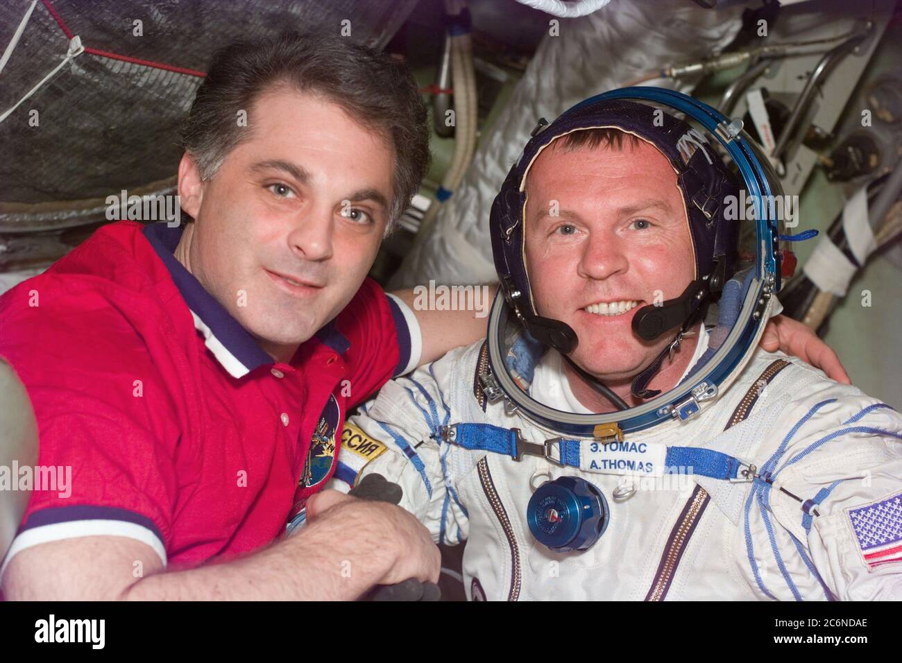 (26 Jan 1998) --- This Electronic Still Camera (ESC) image shows astronauts David A. Wolf and Andrew S. W. Thomas embracing after Thomas' second Russian Sokol spacesuit test, onboard the Russian Mir Space Station.  Thomas is to replace Wolf as cosmonaut guest researcher.  Upon Thomas' arrival to Mir he had problems with his Sokol suit, however, following suit modifications the suit fit properly.  Thomas will be the last American astronaut to serve a tour onboard Mir.  This ESC view was taken on January 26, 1998, at 12:56:15 MET. Stock Photo