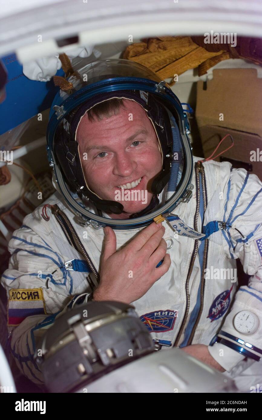 (25 Jan 1998) --- This is the second of a series of three photos onboard Russia's Mir Space Station showing Andrew S. W. Thomas following the donning of the Sokol spacesuit of David A. Wolf, who has been onboard Mir since September 1997.  An earlier fit check of Thomas' Sokol suit did not initially meet specifications required in the event he has to spend time in the pressurized Soyuz spacecraft, now docked to Mir.  After Thomas was checked out in Wolf's suit, sizing modifications were made to his own suit and it was then verified for use by Thomas in the event of a contingency. The image was Stock Photo