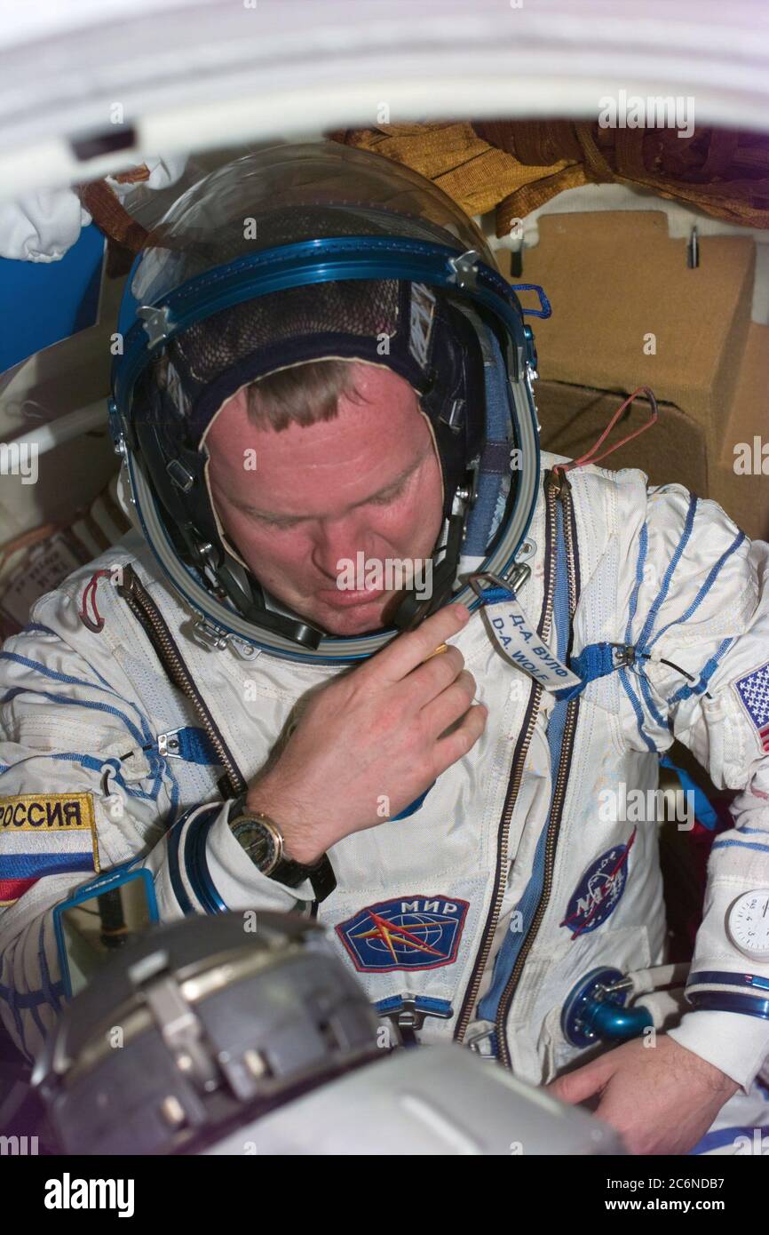 (25 Jan 1998) --- Astronaut Andrew S. W. Thomas dons the Sokol spacesuit of David A. Wolf, who has been onboard Russia's Mir Space Station since September 1997.  An earlier fit check of Thomas' Sokol suit did not initially meet specifications required in the event he has to spend time in the pressurized Soyuz spacecraft, now docked to Mir.  After Thomas was checked out in Wolf's suit, sizing modifications were made to his own suit and it was then verified for use by Thomas in the event of a contingency. Stock Photo