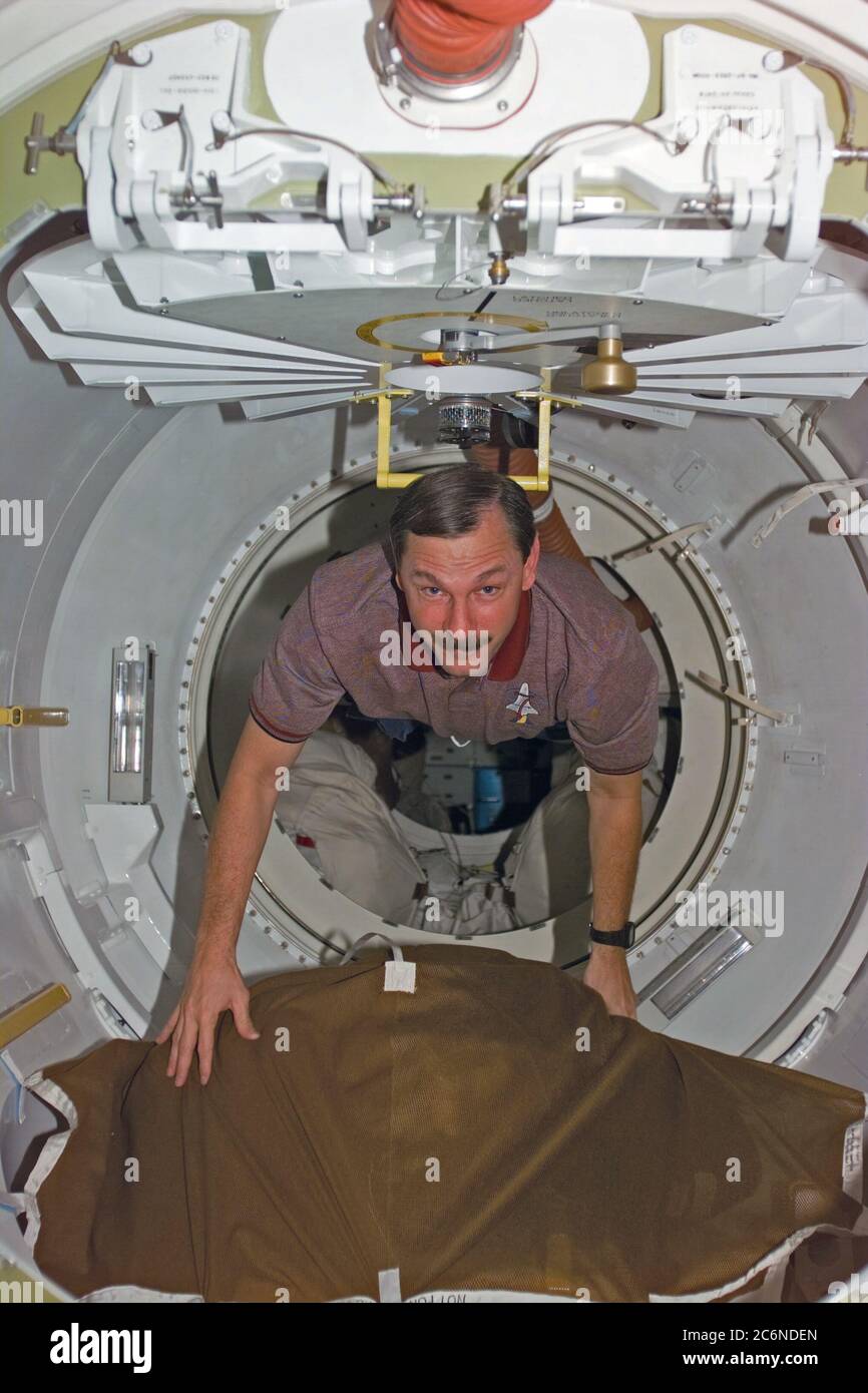 (1 Nov. 1998) --- Astronaut Curtis L. Brown Jr., STS-95 commander, floats through airlock hatchway during Flight Day three activity. The photo was taken with an electronic still camera (ESC) at 01:39:20 GMT, Nov. 1. Stock Photo