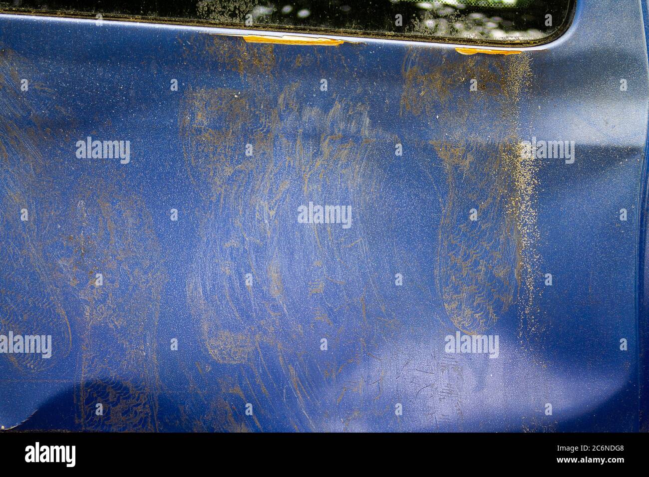 Texture of a rusted car side wall. You can see a lot of rust and a big dent caused by footprints. Stock Photo