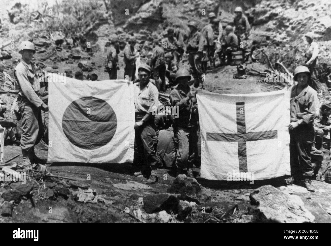 Members of Company F, 147th Infantry, display captured Japanese flags found in an underground hospital, April 11, 1945. Relieving Marine Corps units, the Soldiers of the Ohio National Guard’s 147th Infantry Regiment fought on the island from March to September 1945, clearing the remaining enemy troops, some of whom were hiding in intricate cave systems Stock Photo